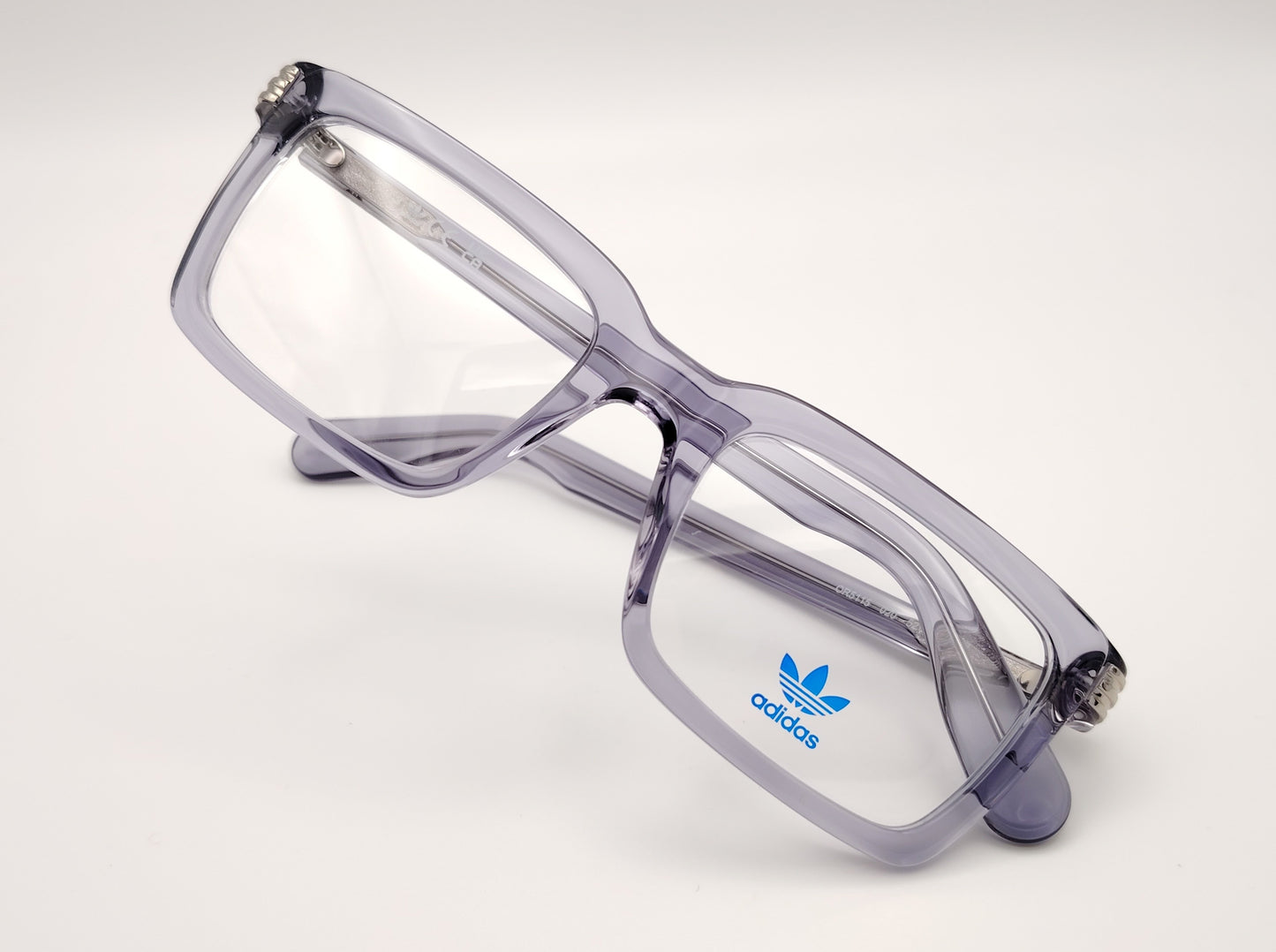 gafas de vista adidas or5115 con montura de acetato en gris translúcido y detalle metático en el talón