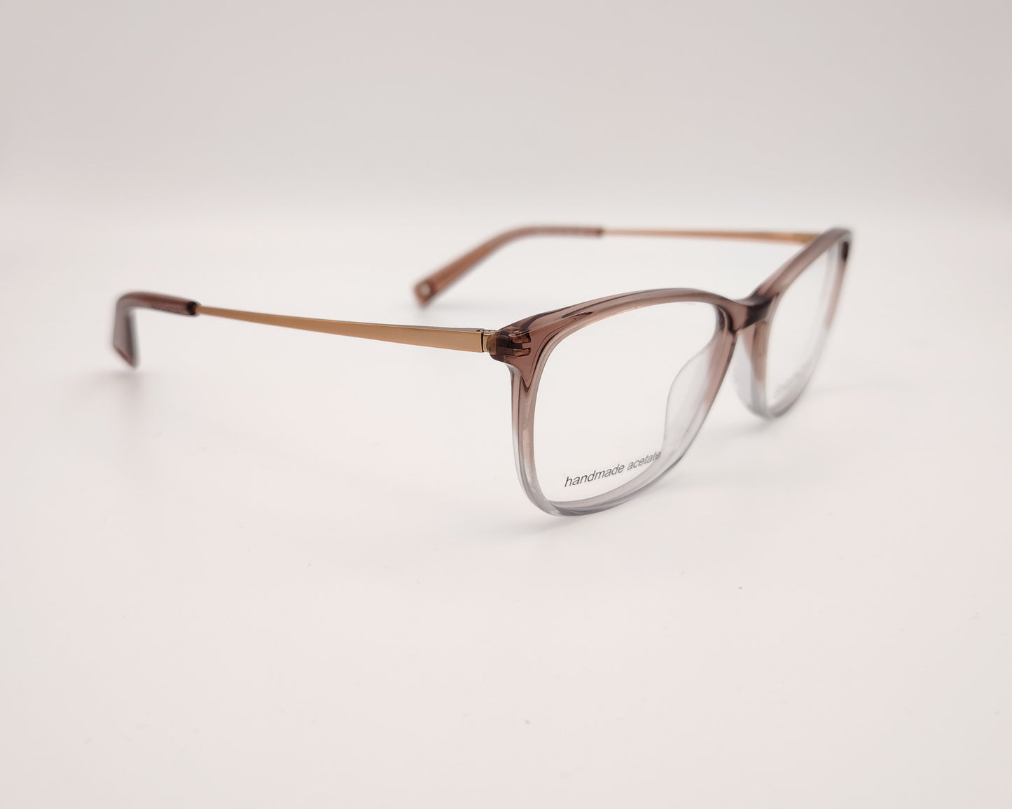 gafas graduadas con montura de acetato translúcido en tono marrón degradado y varillas metálicas doradas con terminales a juego