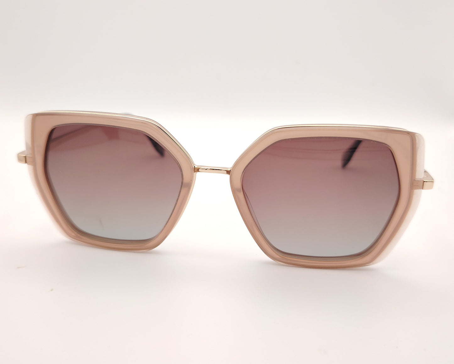gafas de sol polarizadas rosa translúcido con montura geométrica y varillas doradas