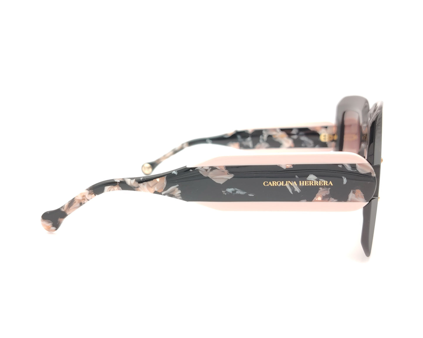 gafas de sol carolina herrera oversize negras con lentes rosadas degradadas y varillas marmoleadas