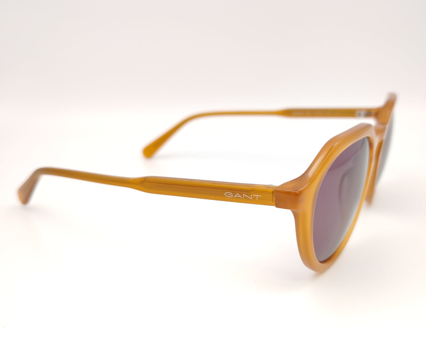 gafas de sol gant forma redonda en acetato color miel con lentes oscuras marrones