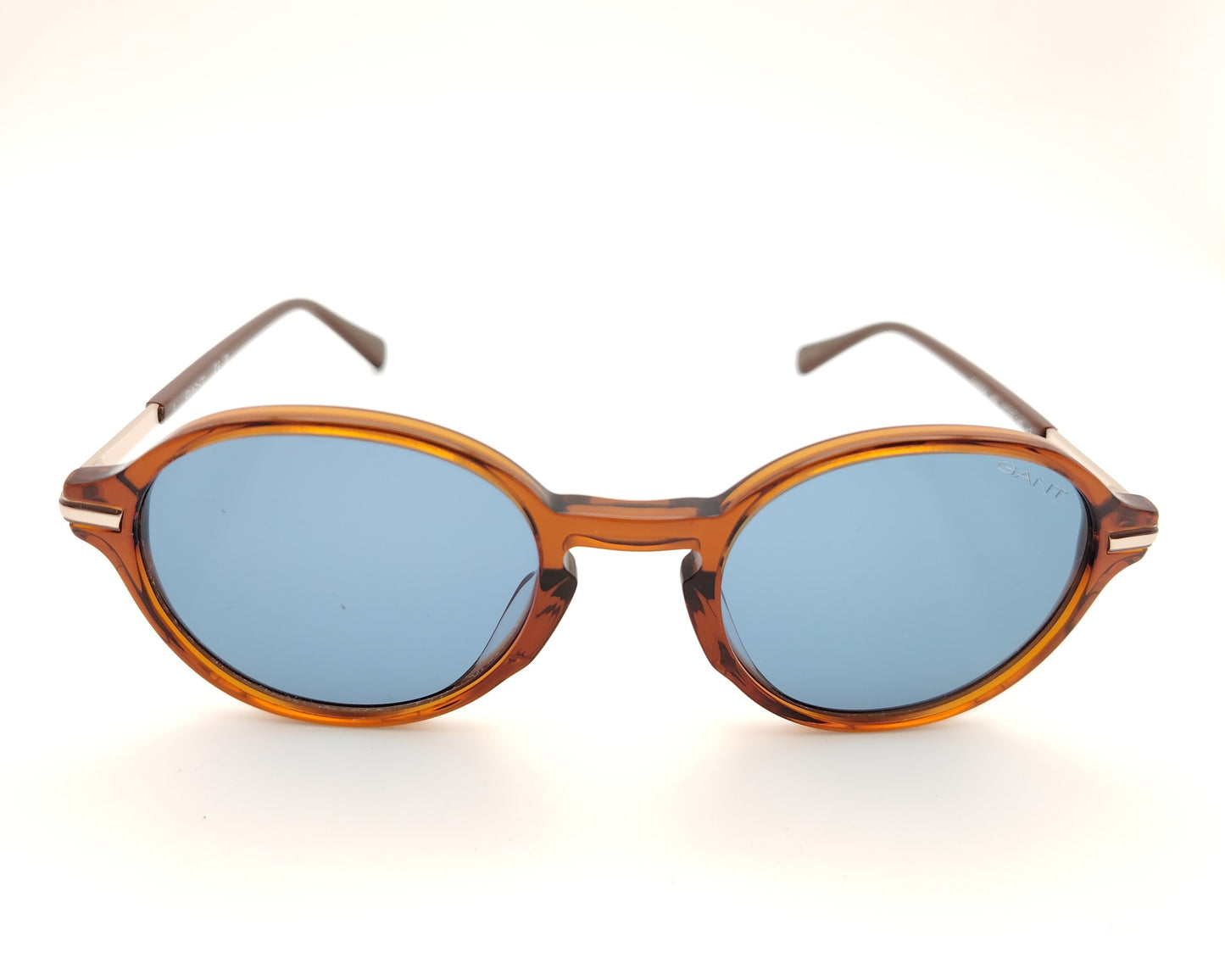 gafas de sol redondas con montura carey marrón y lentes azules