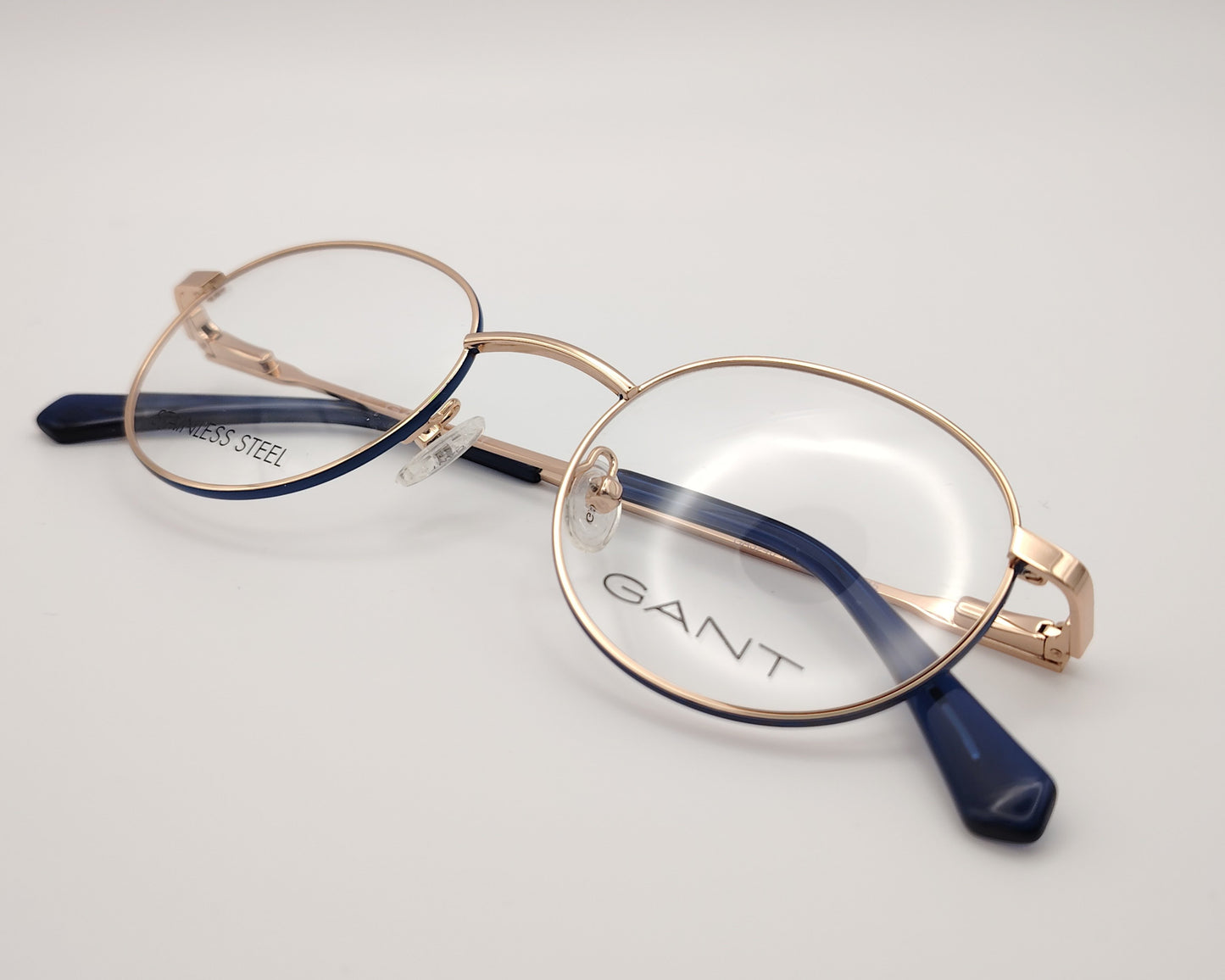 gant ga 3240 032 gafas graduadas montura metálica forma redonda, color oro rosa con los laterales del aro en azul ,varillas finas con terminales en azul