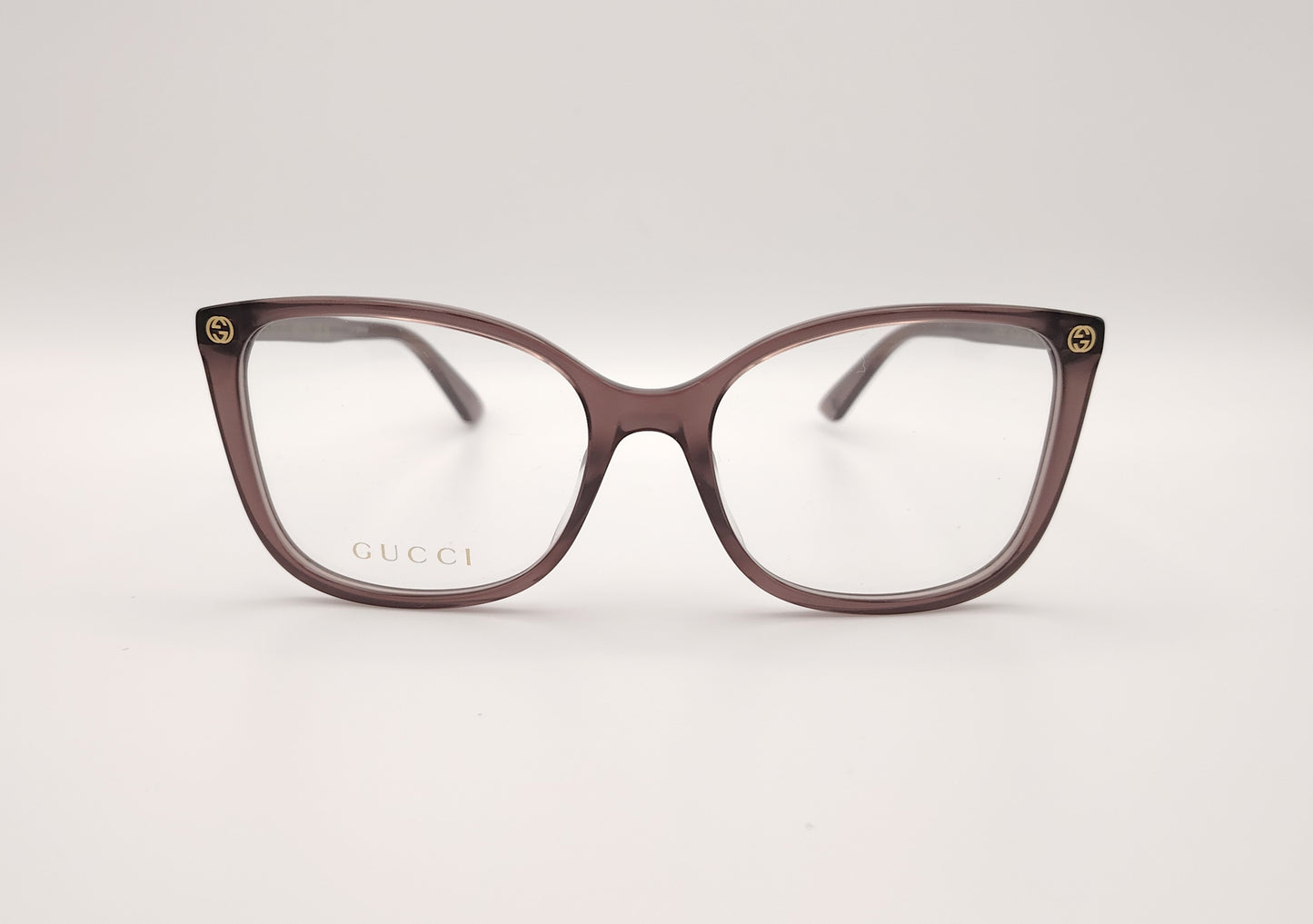 gafas gucci color malva con forma mariposa y detalles dorados