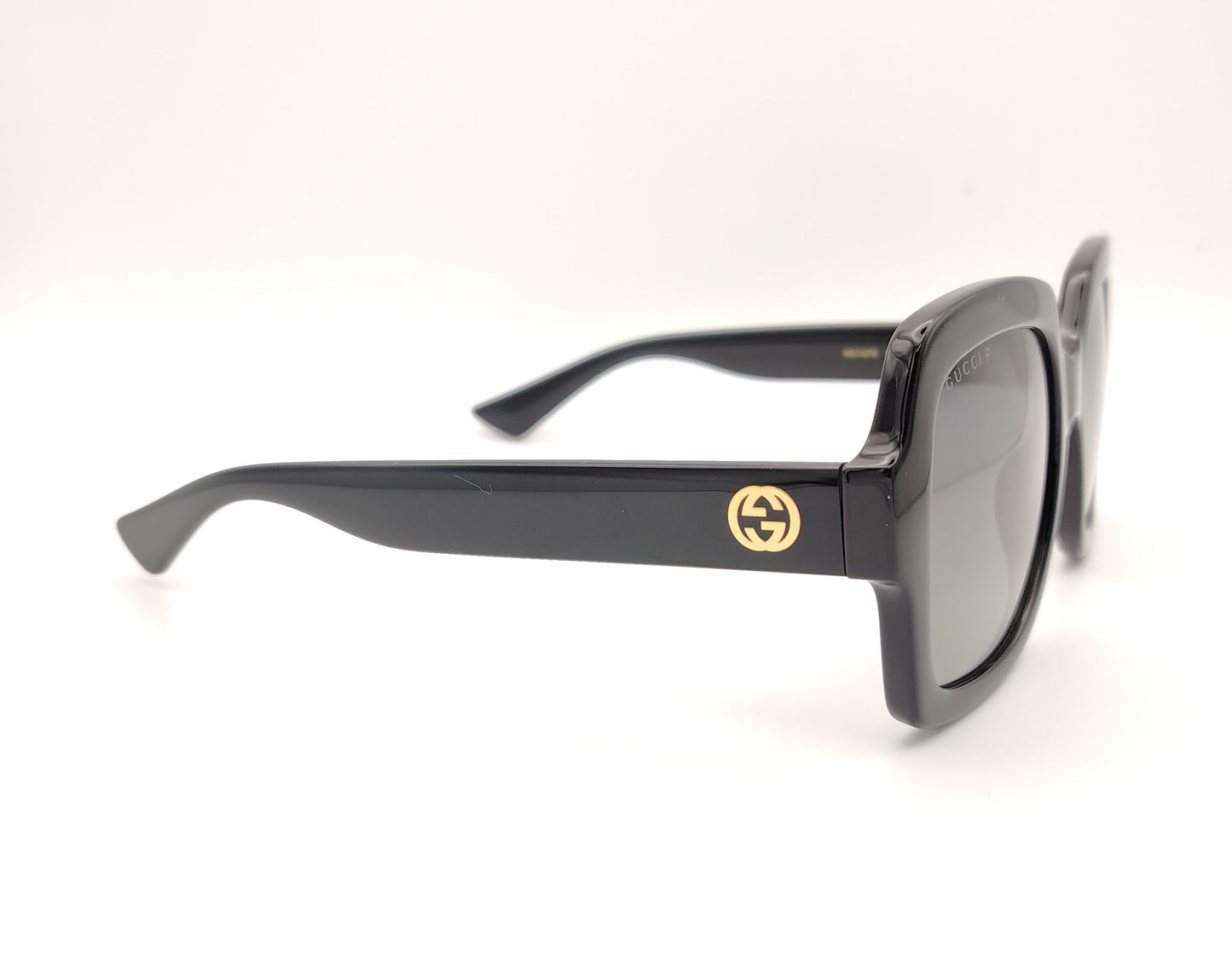gafas de sol gucci negras con montura cuadrada oversize y logo dorado en la varilla