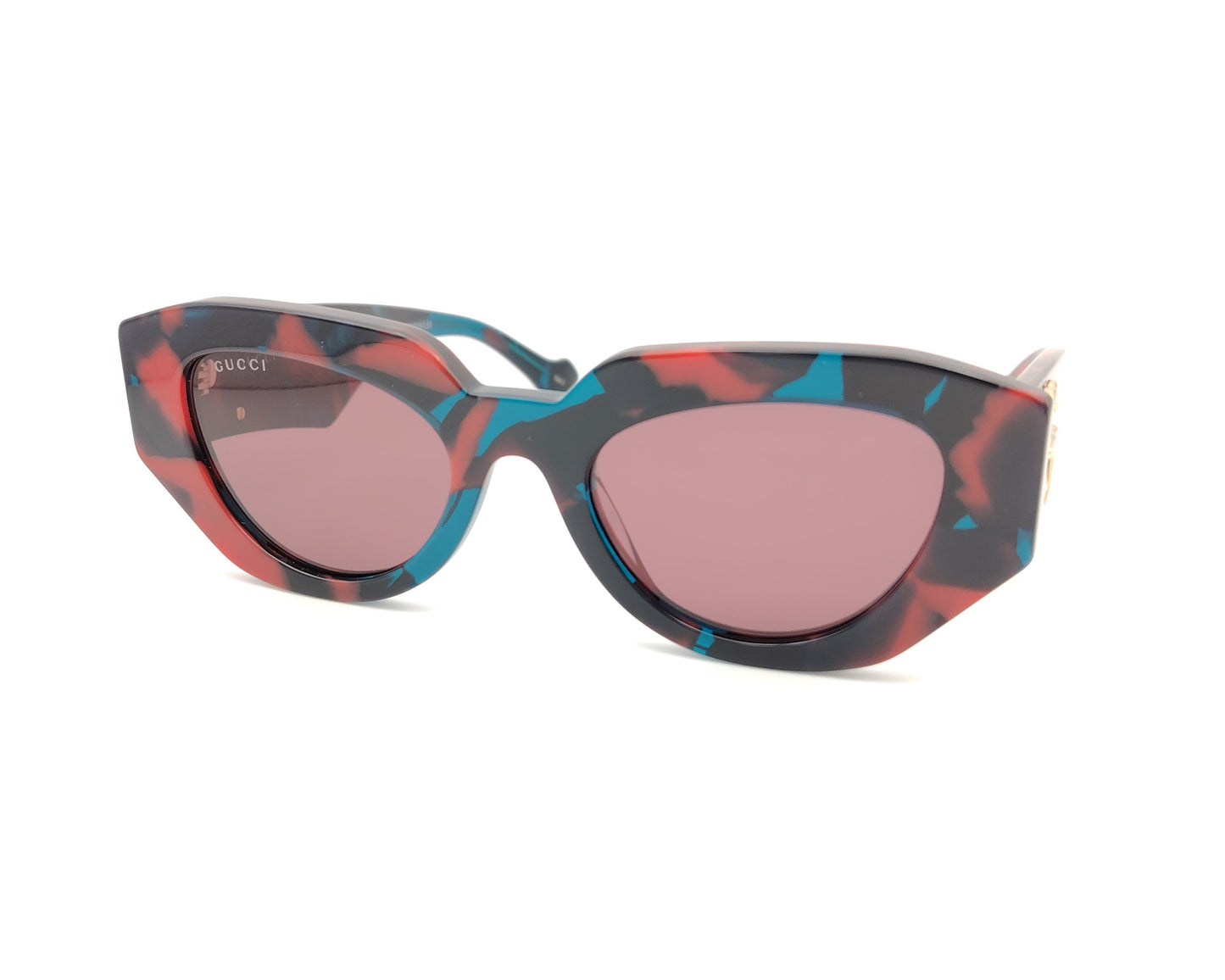 gafas de sol gucci con montura geométrica marmolada en rojo azul y negro y lentes rosadas