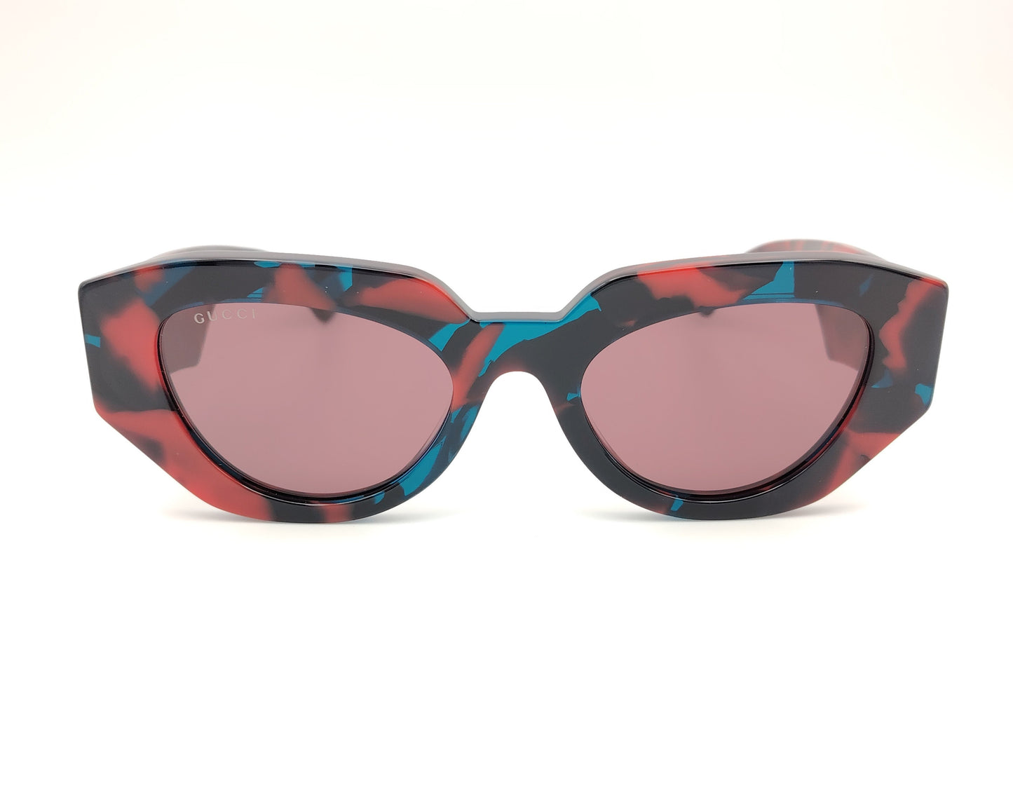 gafas de sol gucci con montura geométrica marmolada en rojo azul y negro y lentes rosadas