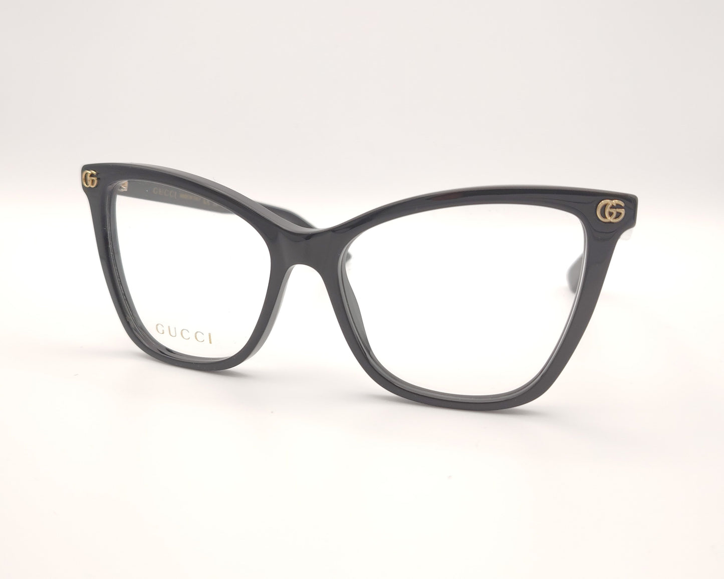 gafas graduadas gucci negras con forma cat eye y detalle dorado en la varilla