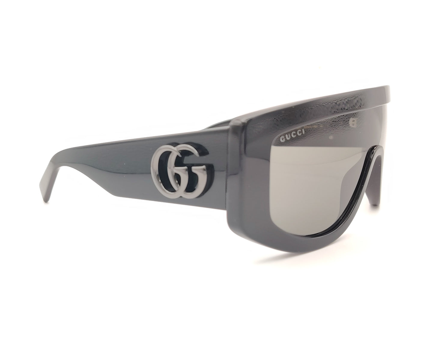 gafas de sol gucci tipo máscara negras con montura ancha y logo metálico gg en las varillas