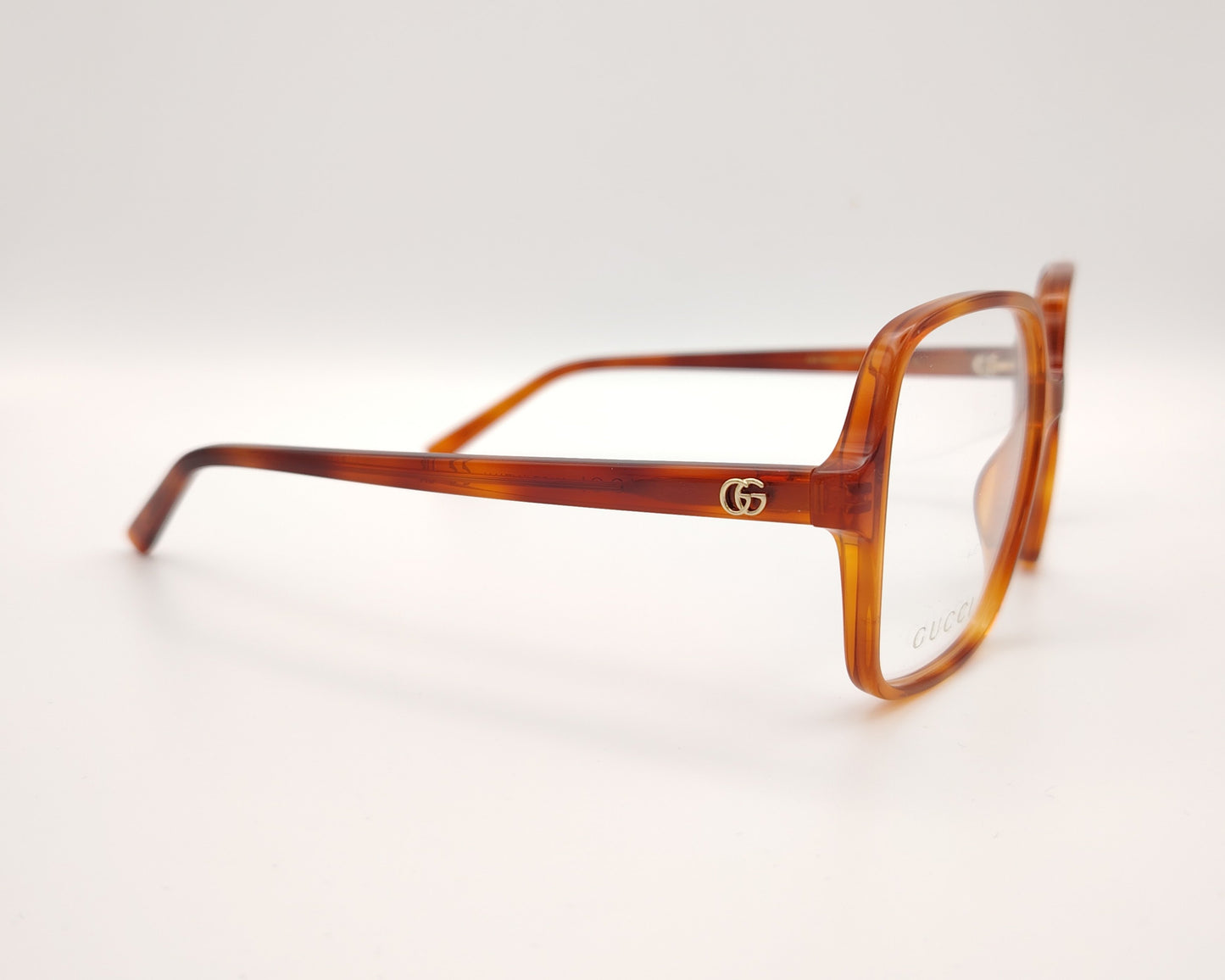 gafas gucci cuadradas de acetato caramelo con logo dorado en las varillas