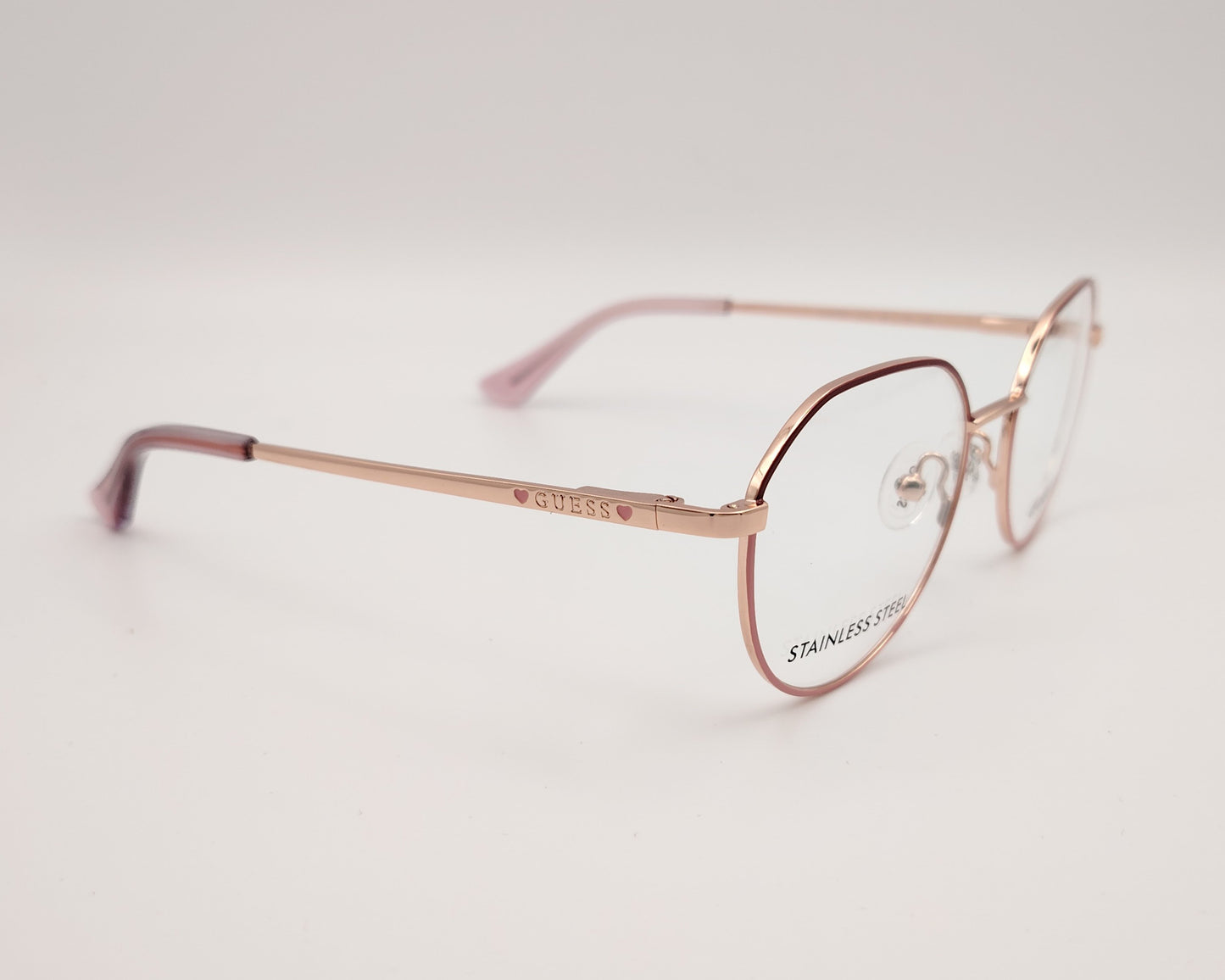 gafas de niña guess de metal dorado con el frente lacado en granate y rosa