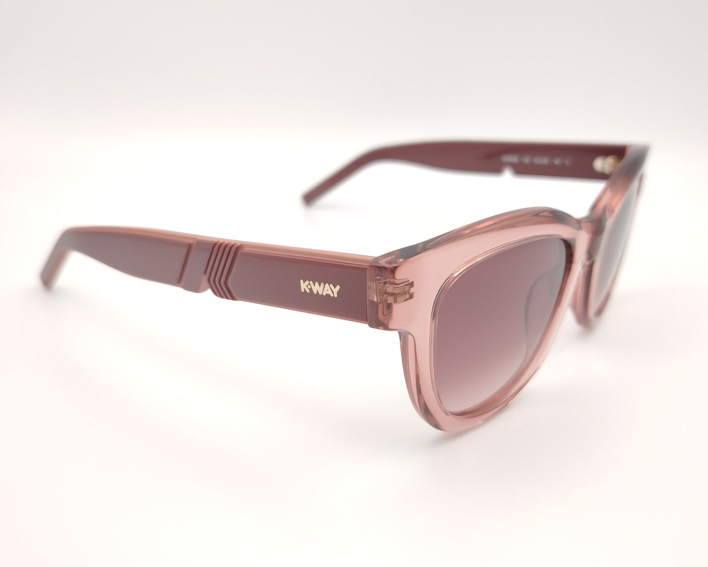 gafa de sol k-way kw0006 72z de forma cat eyes retro con montura gruesa en color rosa traslúcido y lentes degradadas en el mismo tono