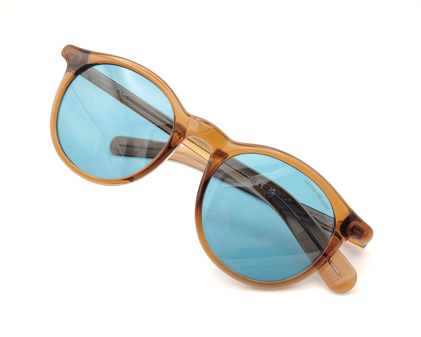 gafas de sol montblanc redondas con montura color ámbar y cristales azules