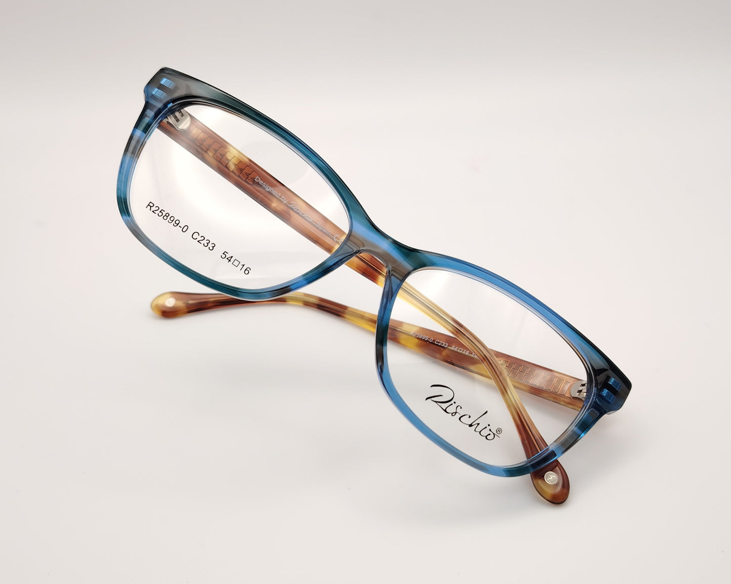 gafas graduadas rischio r25899 c233, montura de acetato en color azul traslúcido, diseño rectangular suavizado, varillas con estampado habana claro