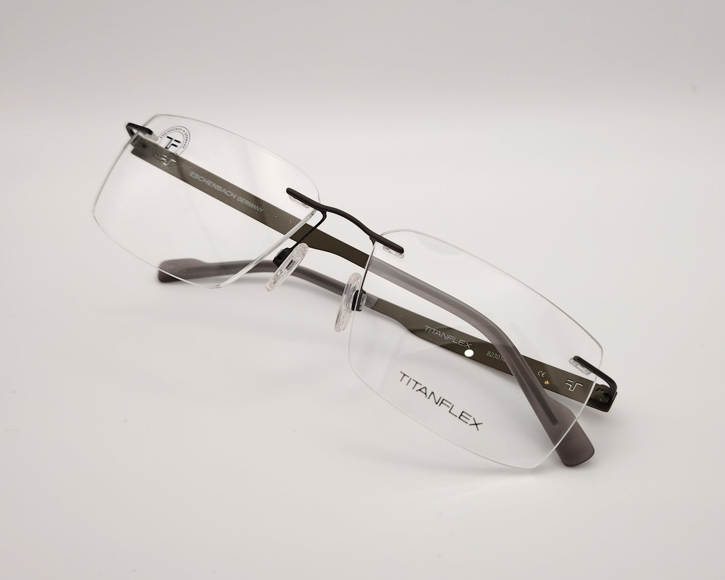 gafas graduadas titanflex sin montura con varillas metálicas en color gris verdoso y plaquetas ajustables