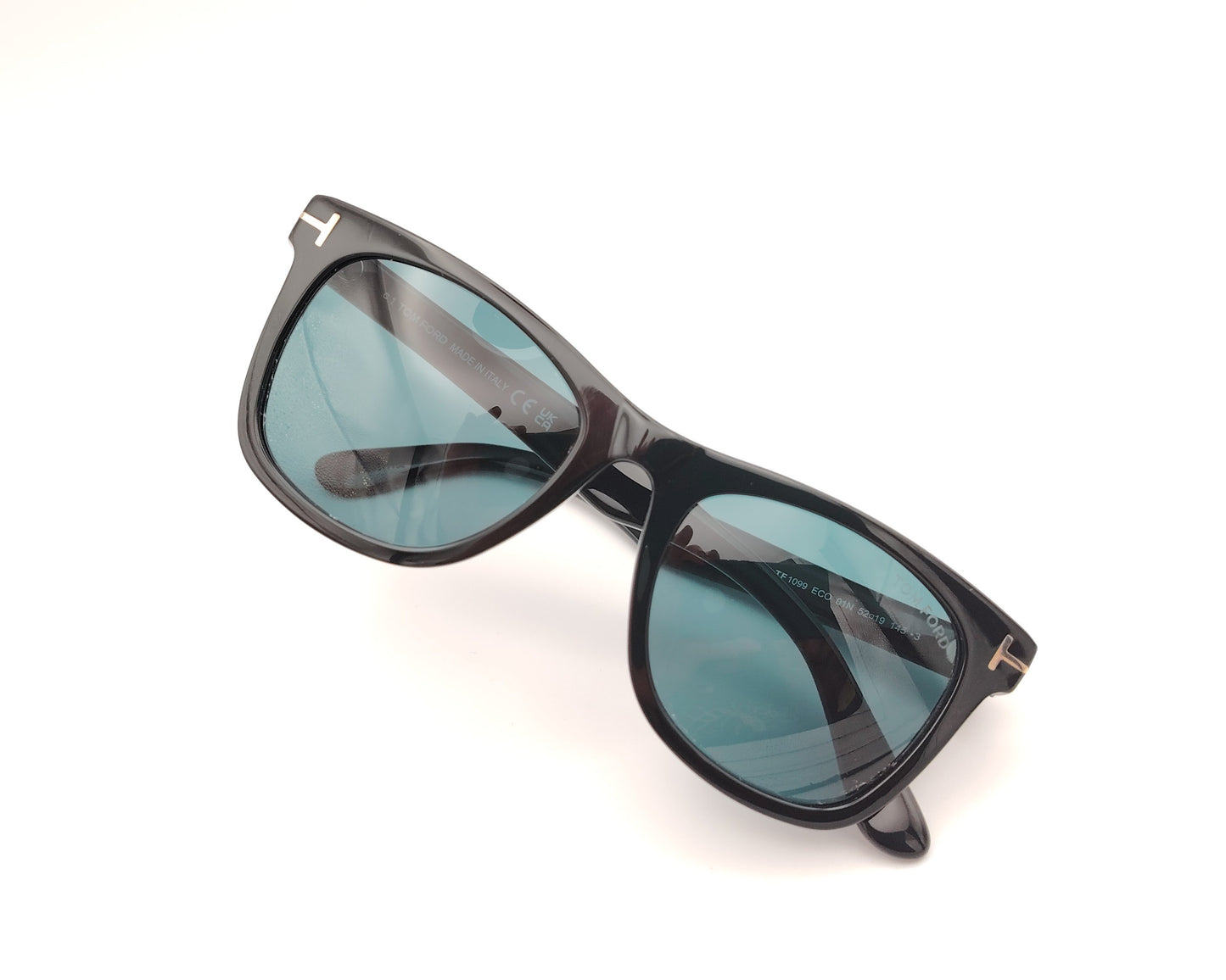 gafas de sol tom ford tf1099 eco 01n con montura en formato cuadrado de acetato en color negro y detalle metálico en forma de t en las varillas , lentes negras