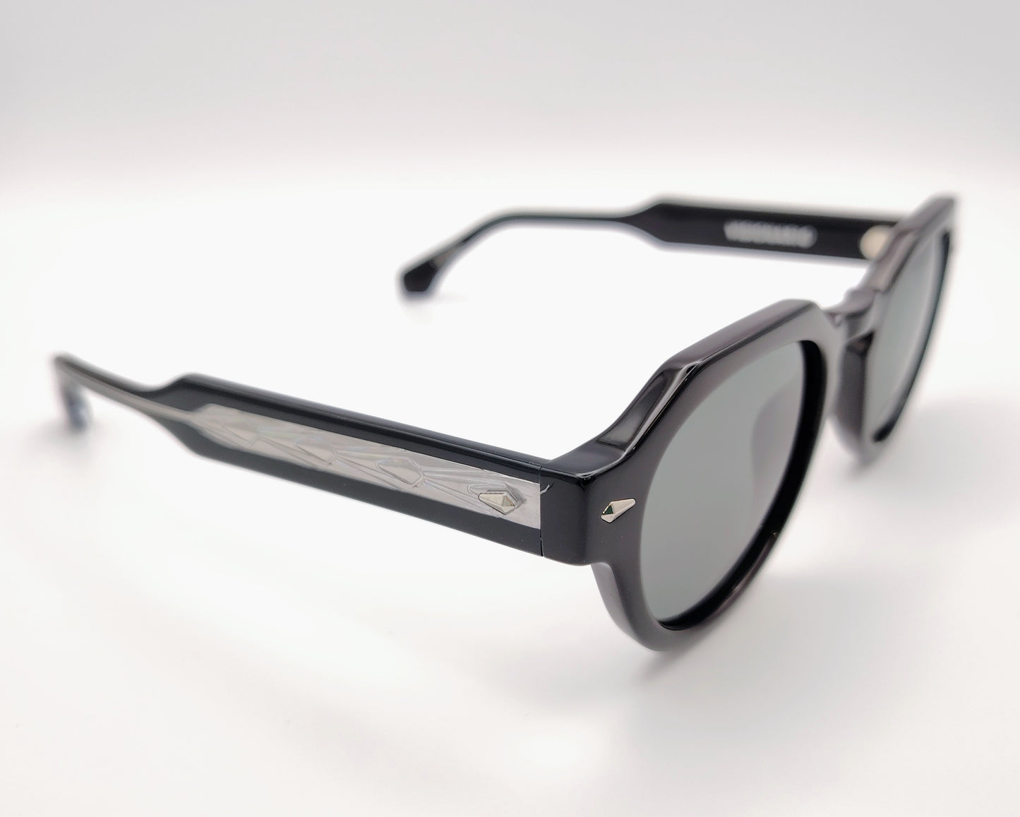 gafas de sol visionario pascal 01, montura redonda de acetato negro con diseño geométrico, detalles metálicos en las bisagras, lentes verdes polarizadas, estilo vanguardista y sofisticado