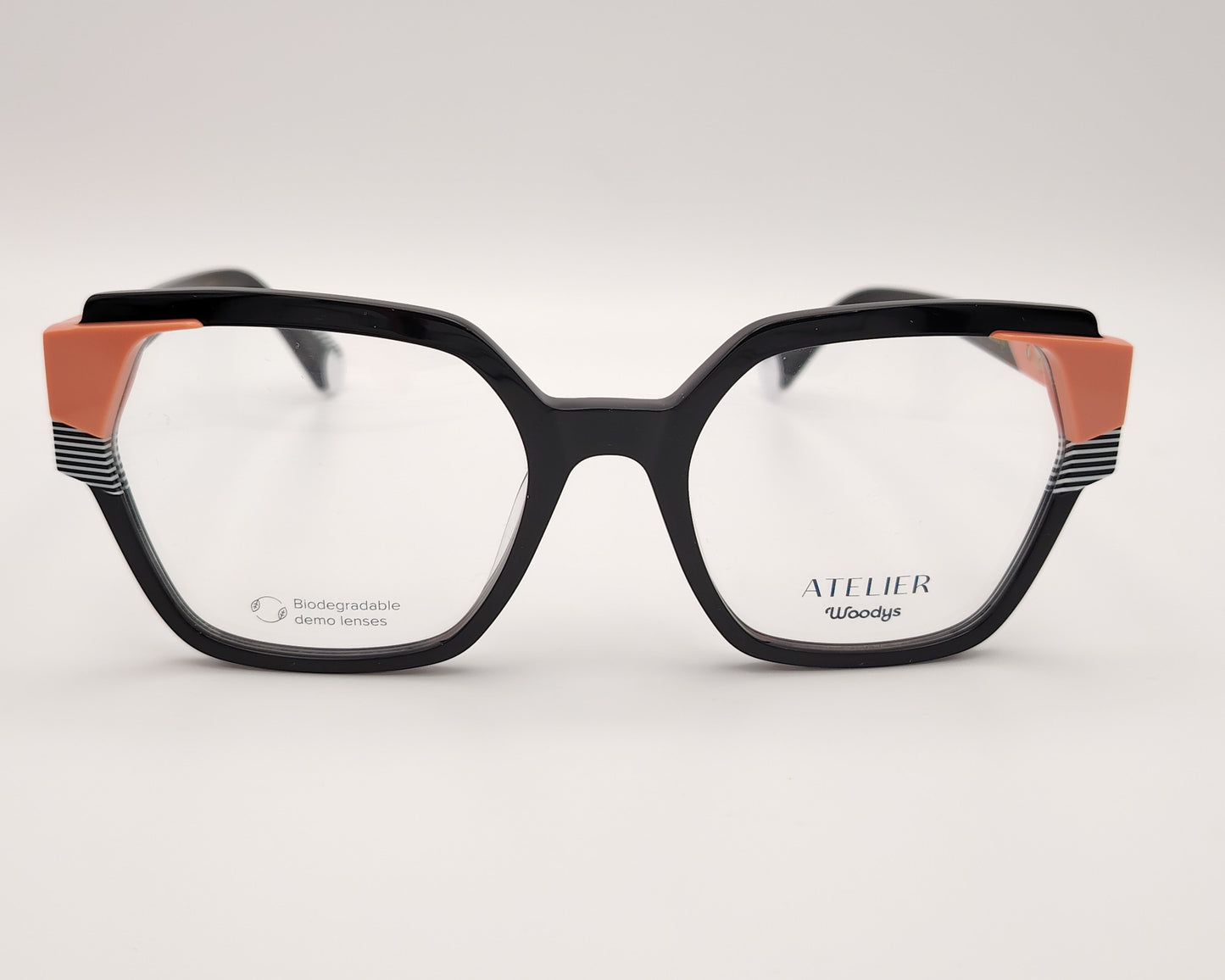 gafas graduadas woodys atelier unknown 01 de acetato negro con forma geométrica cuadrada y detalles arquitectónicos en color coral y rayas blancas y negras en las esquinas superiores y varillas