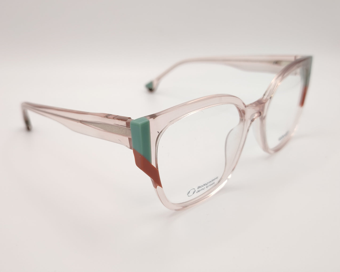 gafas graduadas woodys dagmar 04 con montura geométrica en acetato translúcido de color rosa clarito detalles en las esquinas en tonos verde y coral