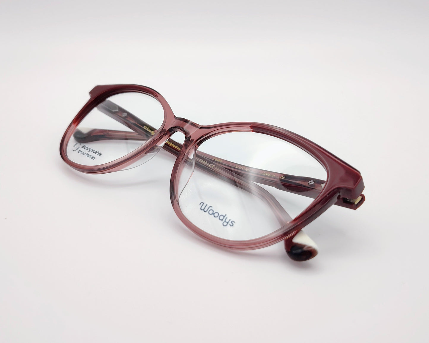 woodys dahlia 03 montura de acetato en forma redondeada y ligeramente cat eyes, en color rosa traslúcido y granate, ligera y cómoda