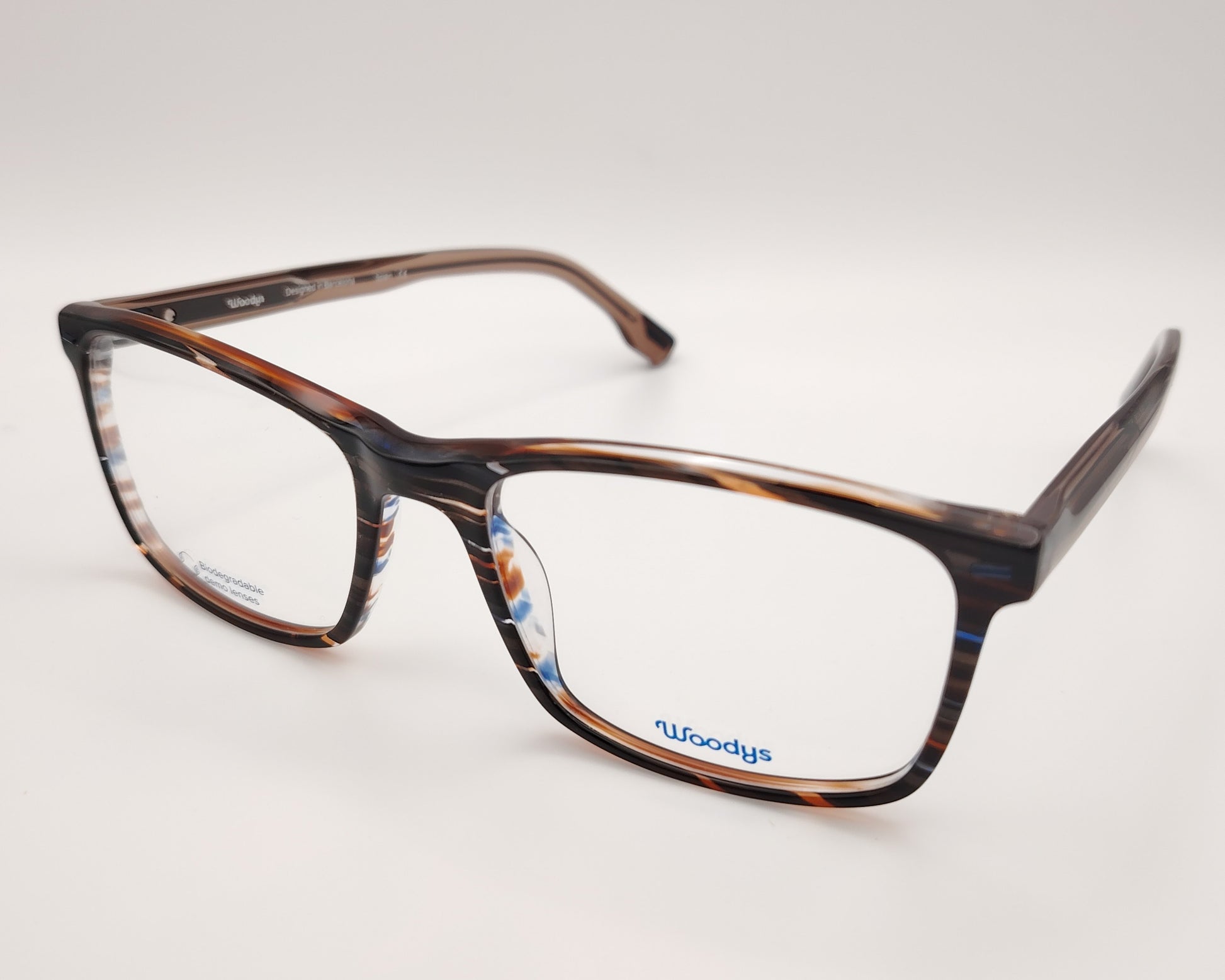 gafas graduadas woodys ford 02 con montura rectangular de acetato en tonalidades carey con detalles en azul y blanco siguiendo un patrón rayado diseño ligero