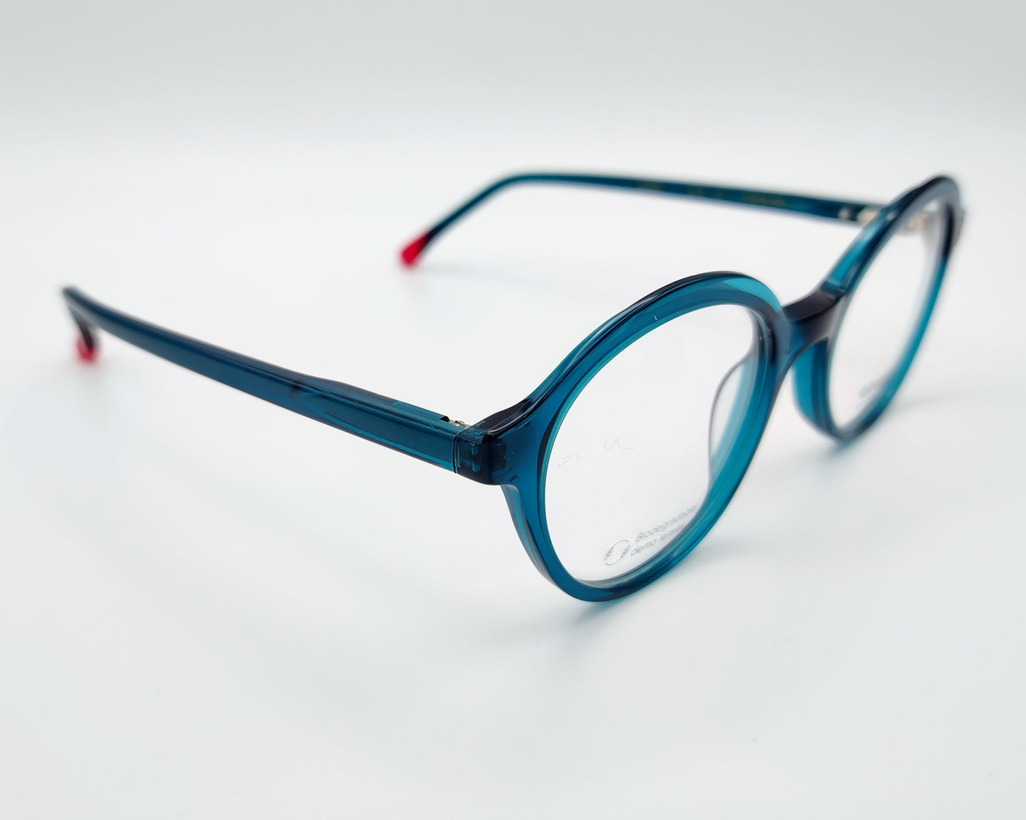 gafas graduadas woodys glis 03 con montura redonda de acetato en tono azul translúcido varillas con terminales en color rojo diseño ligero y cómodo