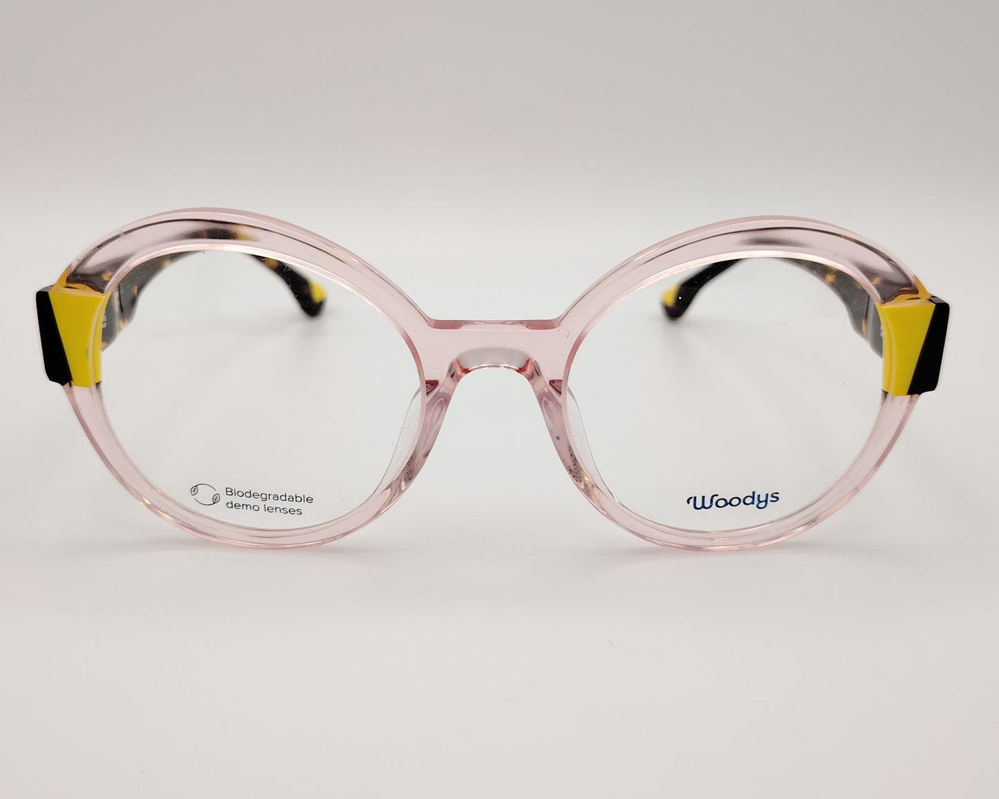 gafas graduadas woodys kilda 05 con montura de acetato en color rosa claro translúcido diseño redondo con detalles geométricos en amarillo y carey en las esquinas varillas en carey