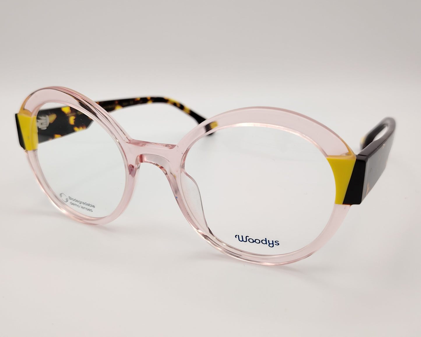 gafas graduadas woodys kilda 05 con montura de acetato en color rosa claro translúcido diseño redondo con detalles geométricos en amarillo y carey en las esquinas varillas en carey