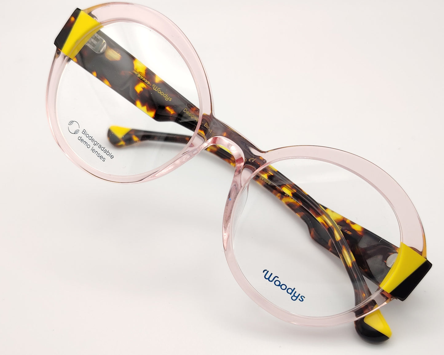 gafas graduadas woodys kilda 05 con montura de acetato en color rosa claro translúcido diseño redondo con detalles geométricos en amarillo y carey en las esquinas varillas en carey