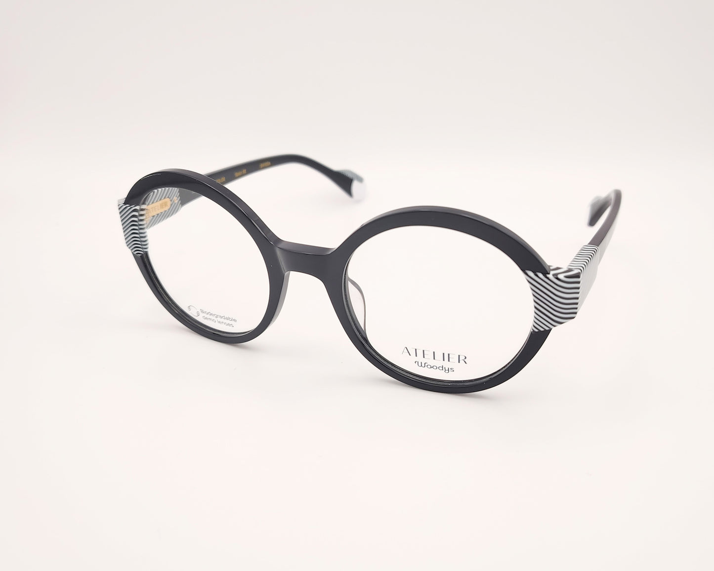 gafas woodys kiss 01 montura de acetato redonda negra detalles geométricos blanco y negro diseño elegante y moderno