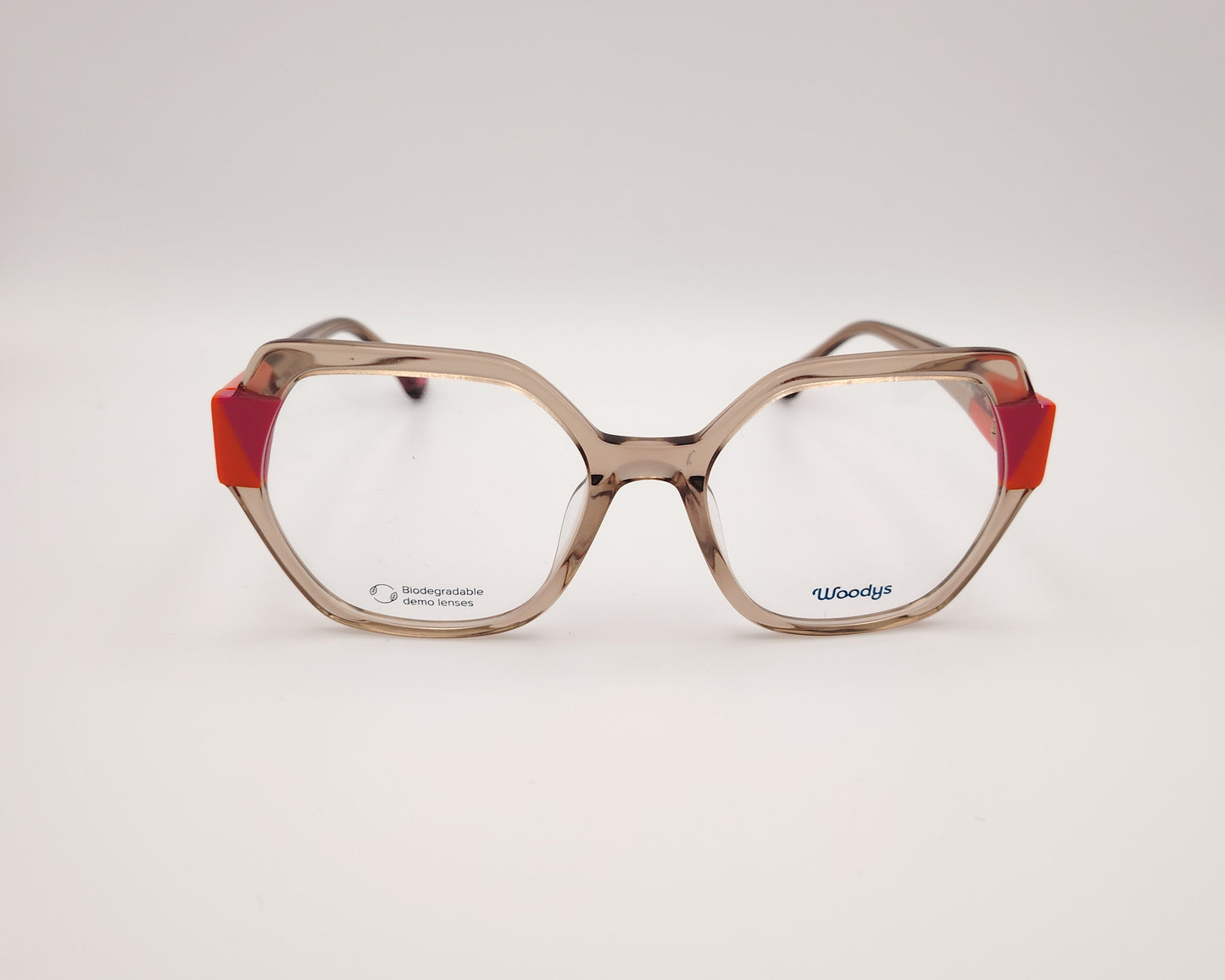 gafas woodys savoye 04 montura geométrica nude translúcido detalles naranja y fucsia diseño moderno y atrevido