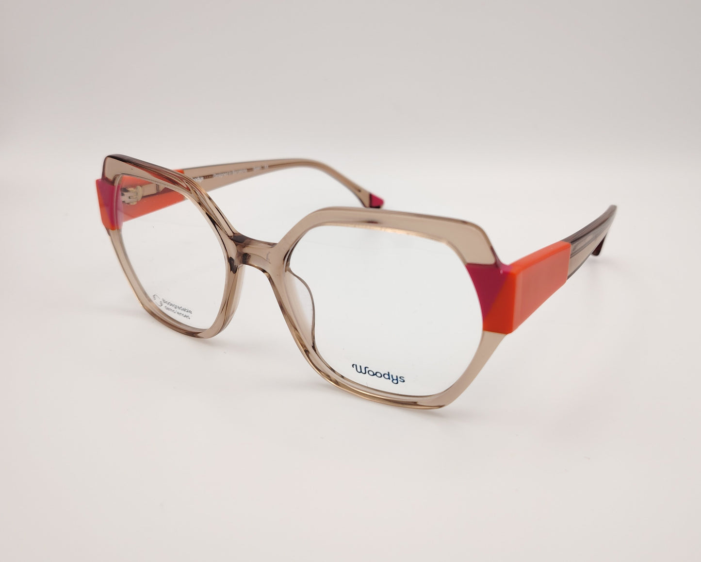 gafas woodys savoye 04 montura geométrica nude translúcido detalles naranja y fucsia diseño moderno y atrevido