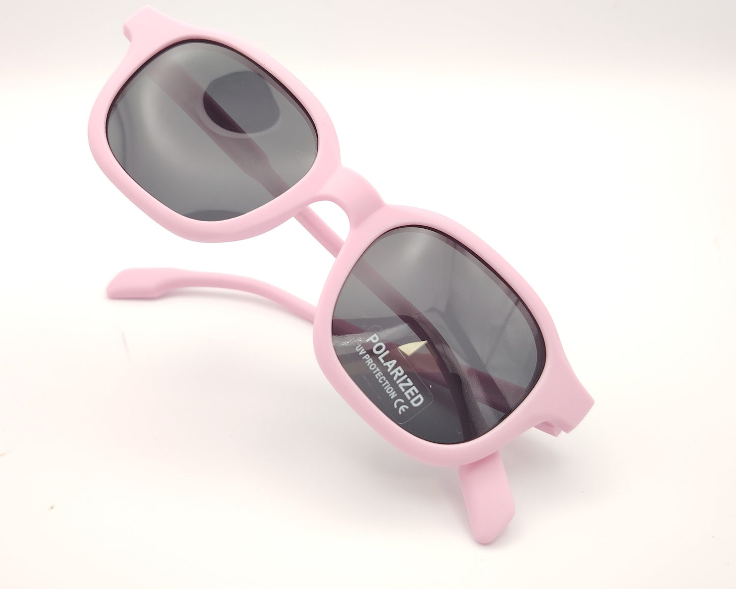 gafas de sol infantiles polarizadas con montura rosa claro y lentes grises con protección uv.