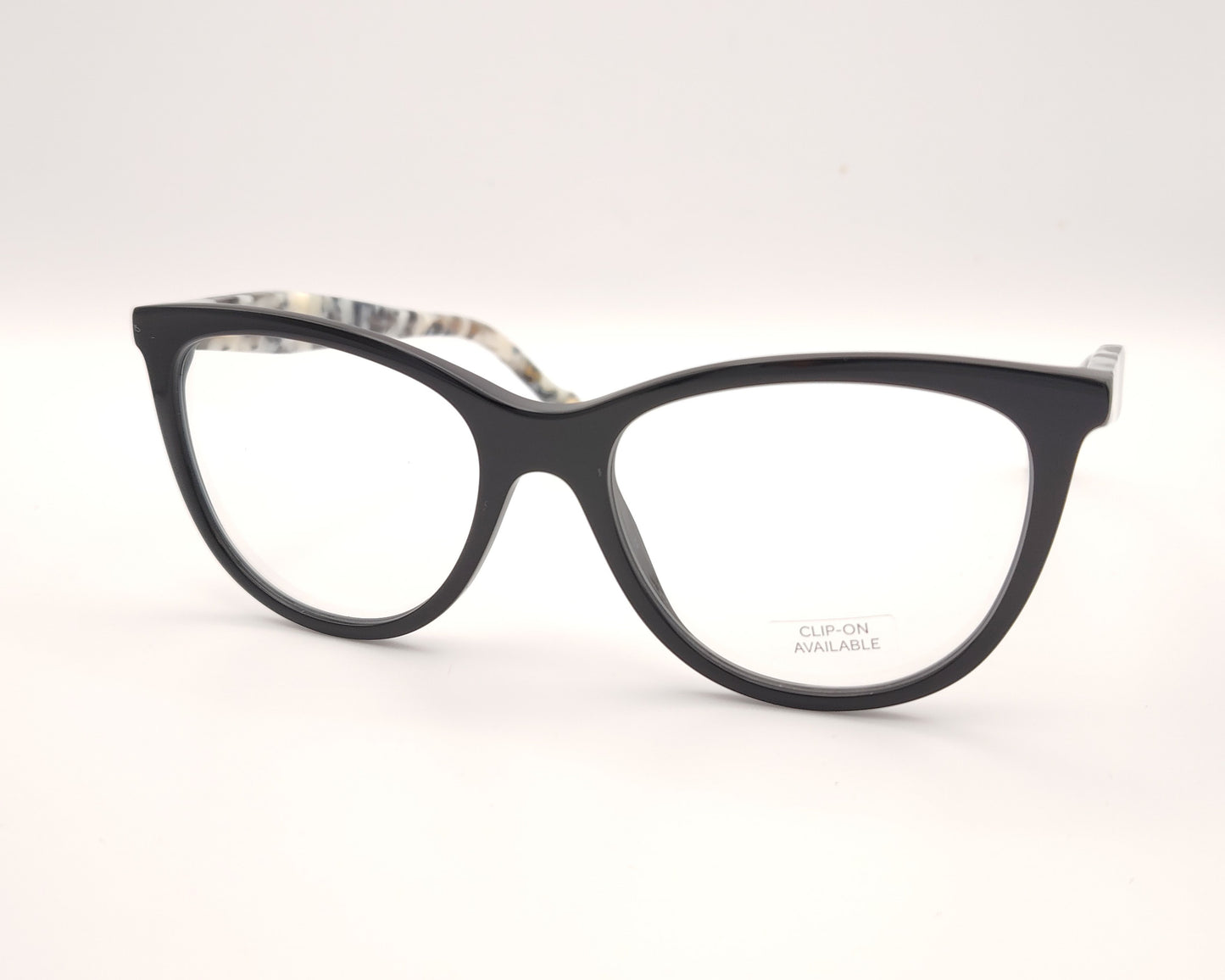 gafas carolina herrera negras con varillas moteadas y clip-on solar con lentes oscuras