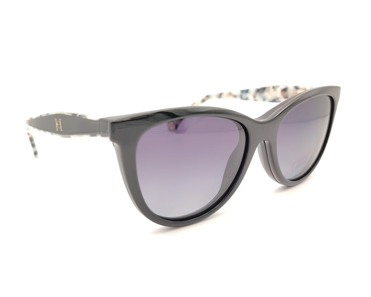 gafas carolina herrera negras con varillas moteadas y clip-on solar con lentes oscuras