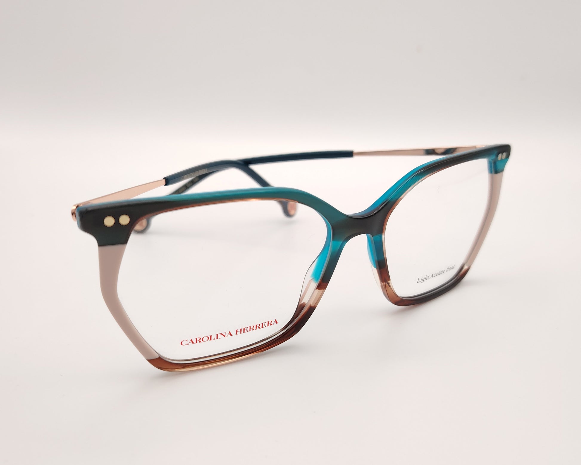 gafas graduadas carolina herrera de acetato fino en azul turquesa, beige y carey con varillas metálicas doradas