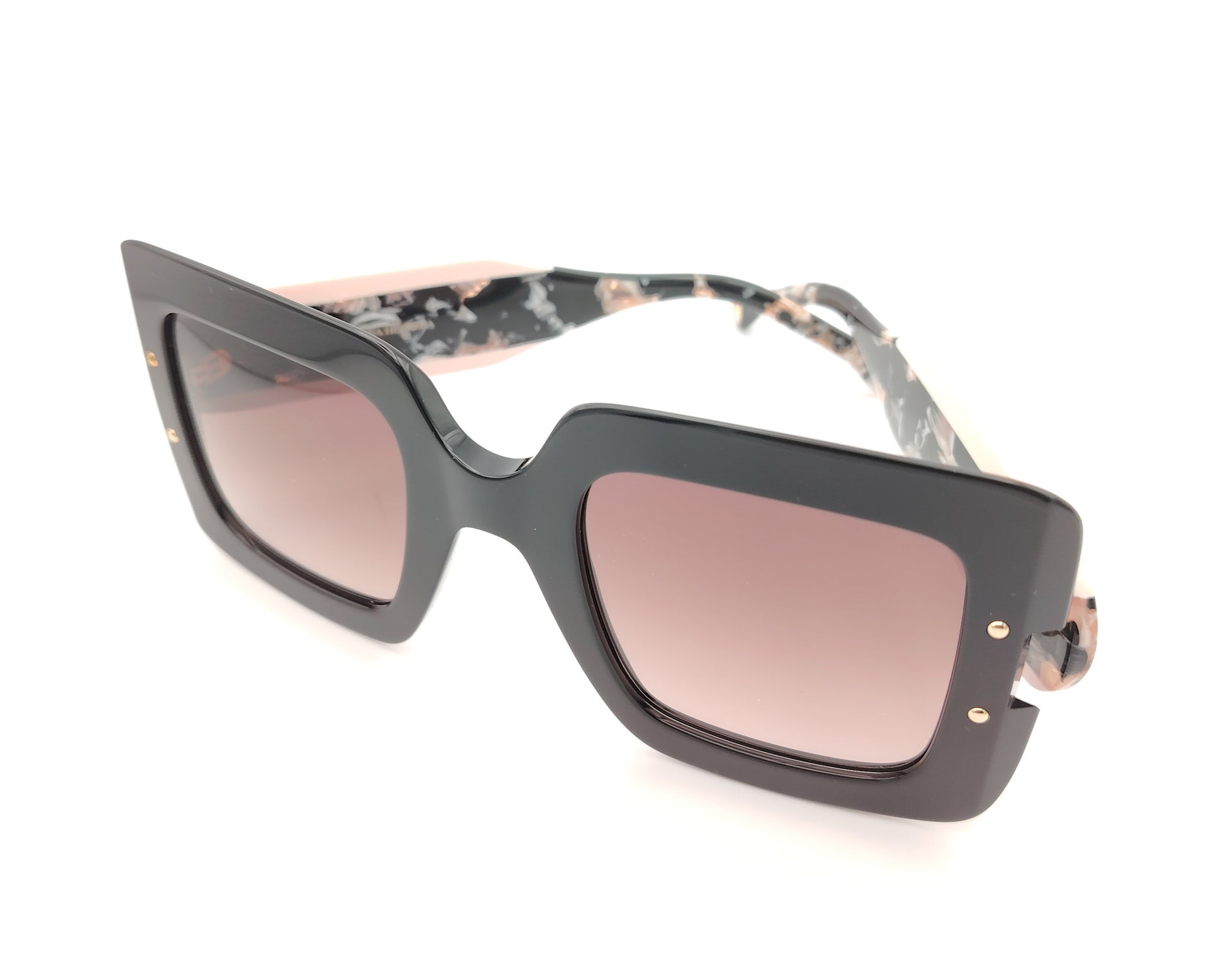 gafas de sol carolina herrera oversize negras con lentes rosadas degradadas y varillas marmoleadas