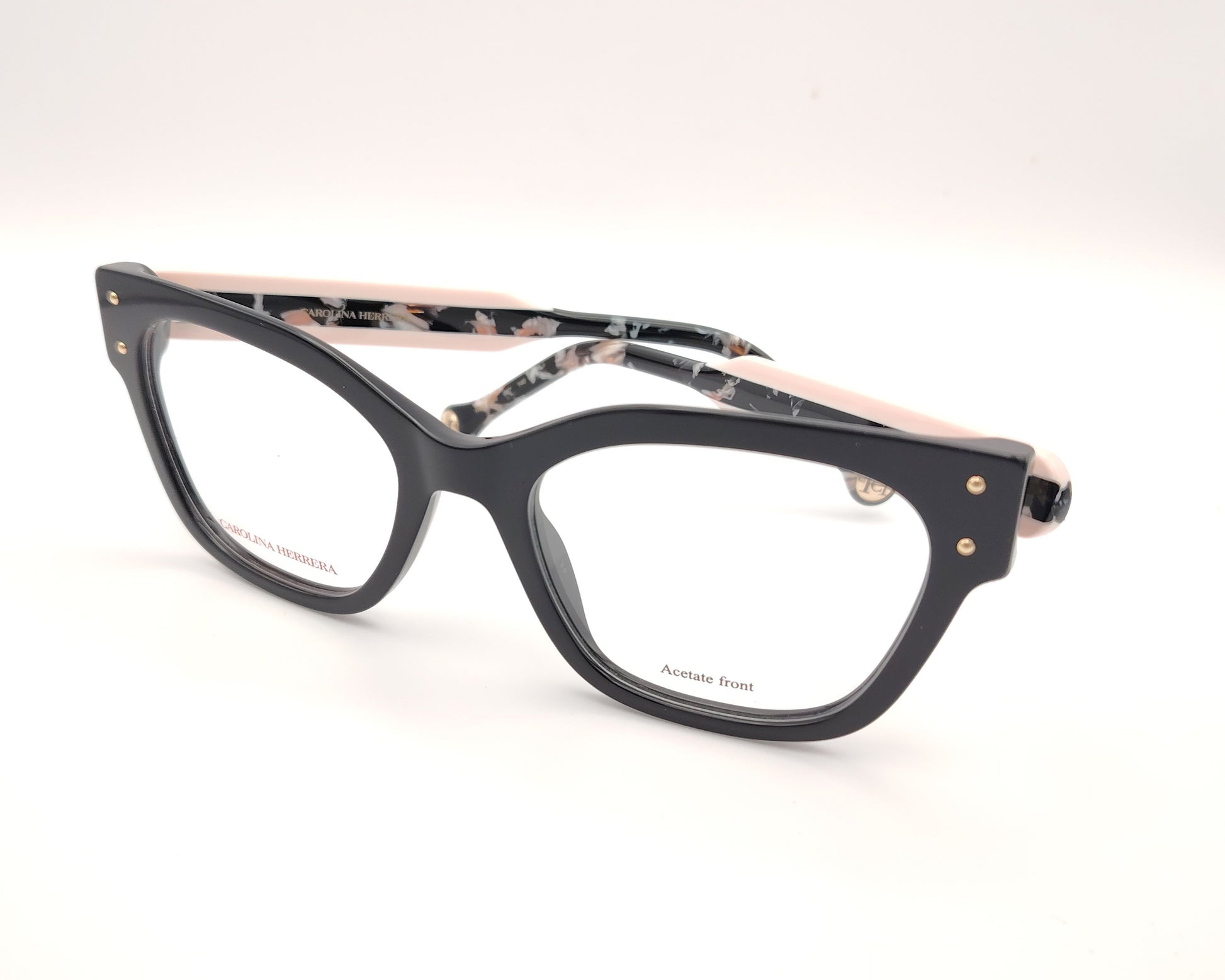 gafas graduadas carolina herrera de forma cuadrada en negro con varillas rosa claro y detalles marmolados