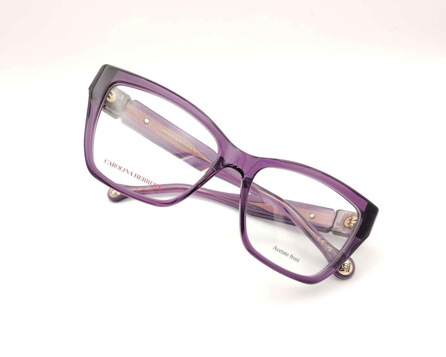 gafas graduadas carolina herrera de forma cuadrada en acetato translúcido morado con detalle dorado en las varillas
