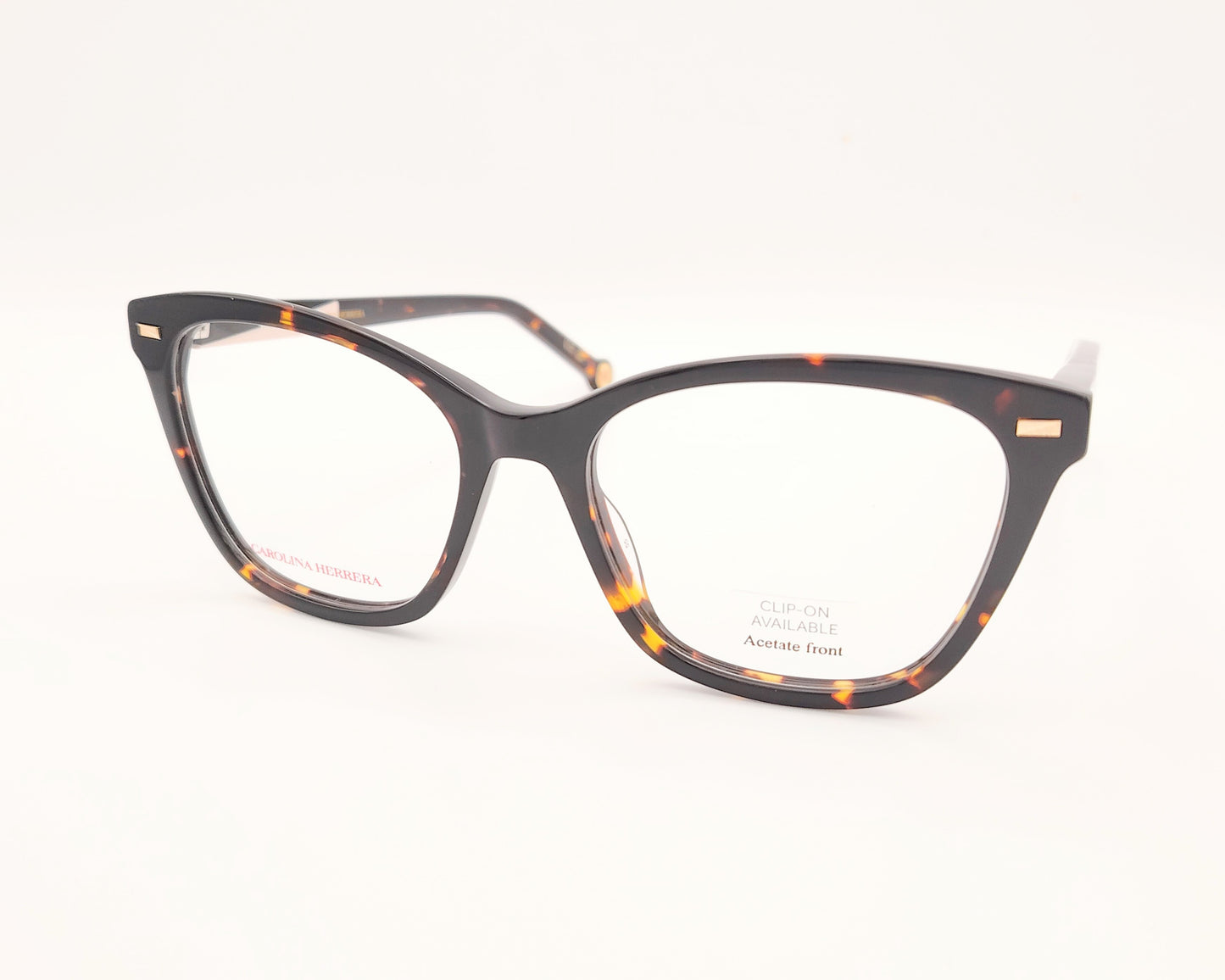 gafas graduadas carolina herrera de forma cat eye en carey oscuro con varillas negro y rosa claro y clip on solar