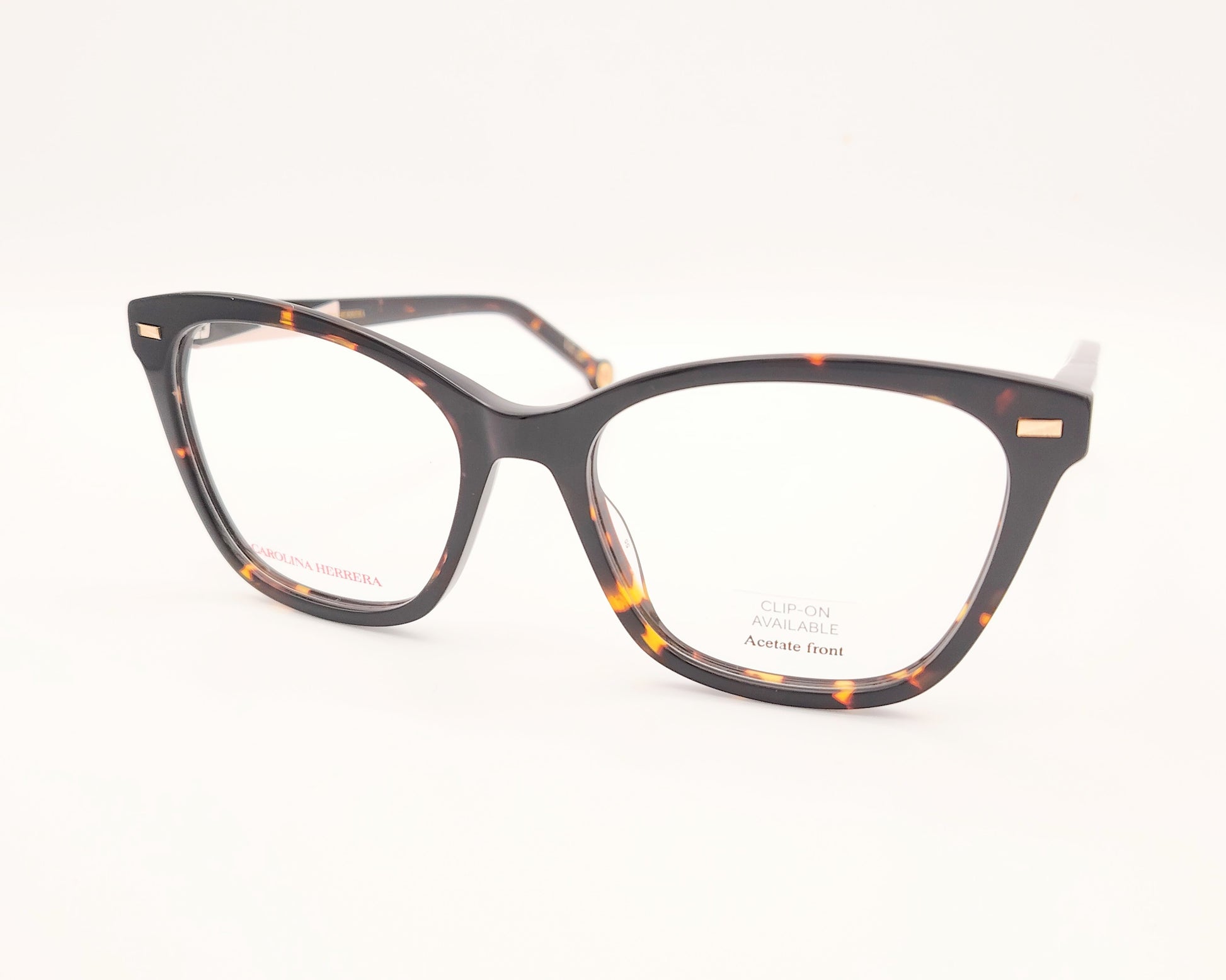gafas graduadas carolina herrera de forma cat eye en carey oscuro con varillas negro y rosa claro y clip on solar