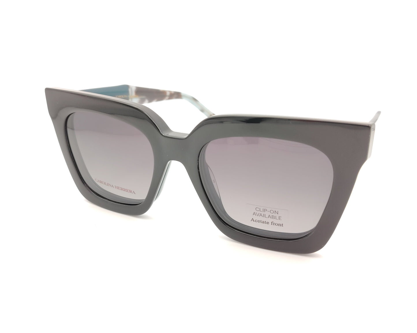 gafas carolina herrera azul petróleo con clip solar negro y forma geométrica