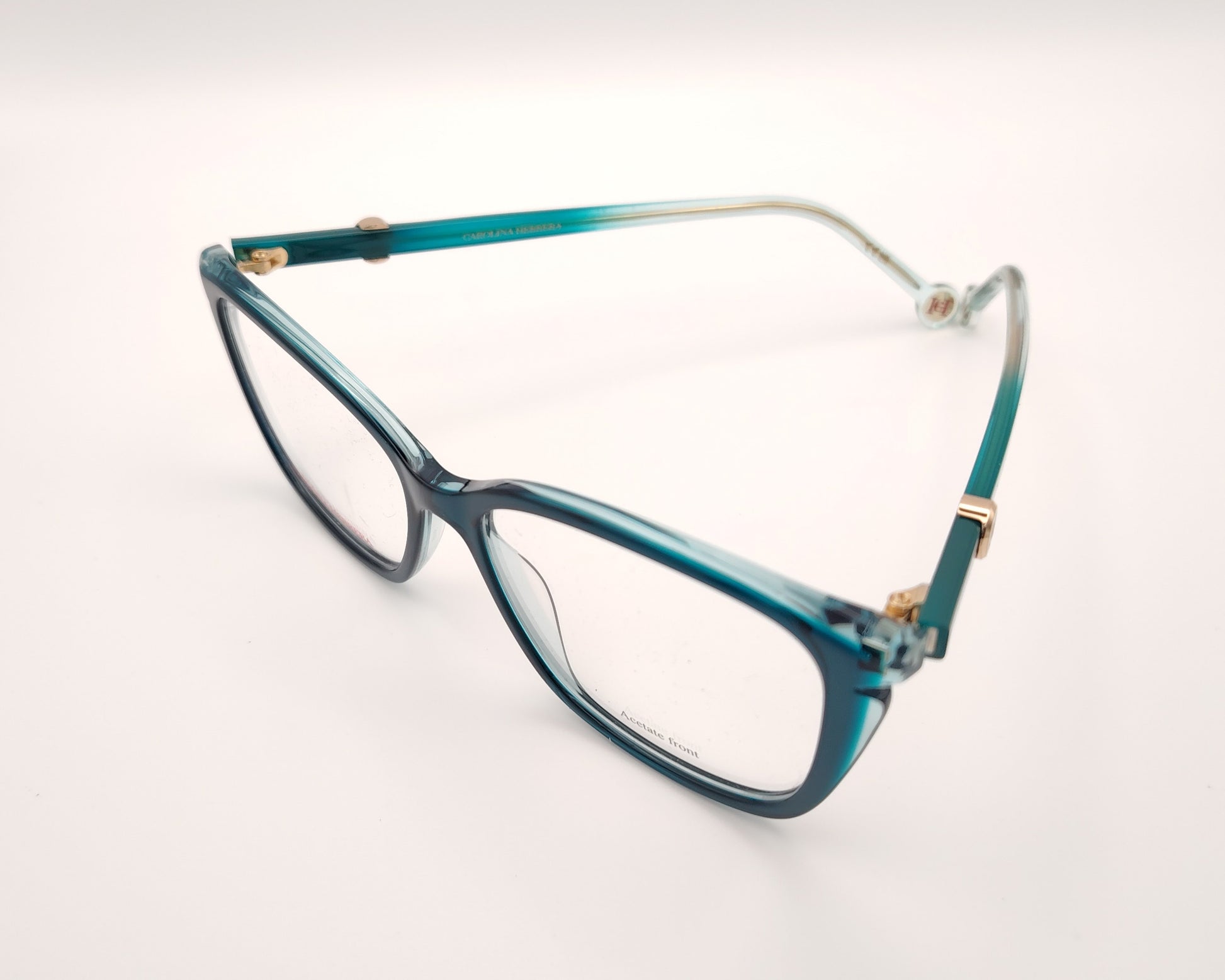 gafas graduadas carolina herrera azul petróleo translúcidas con forma cat eye  suave y detalle dorado