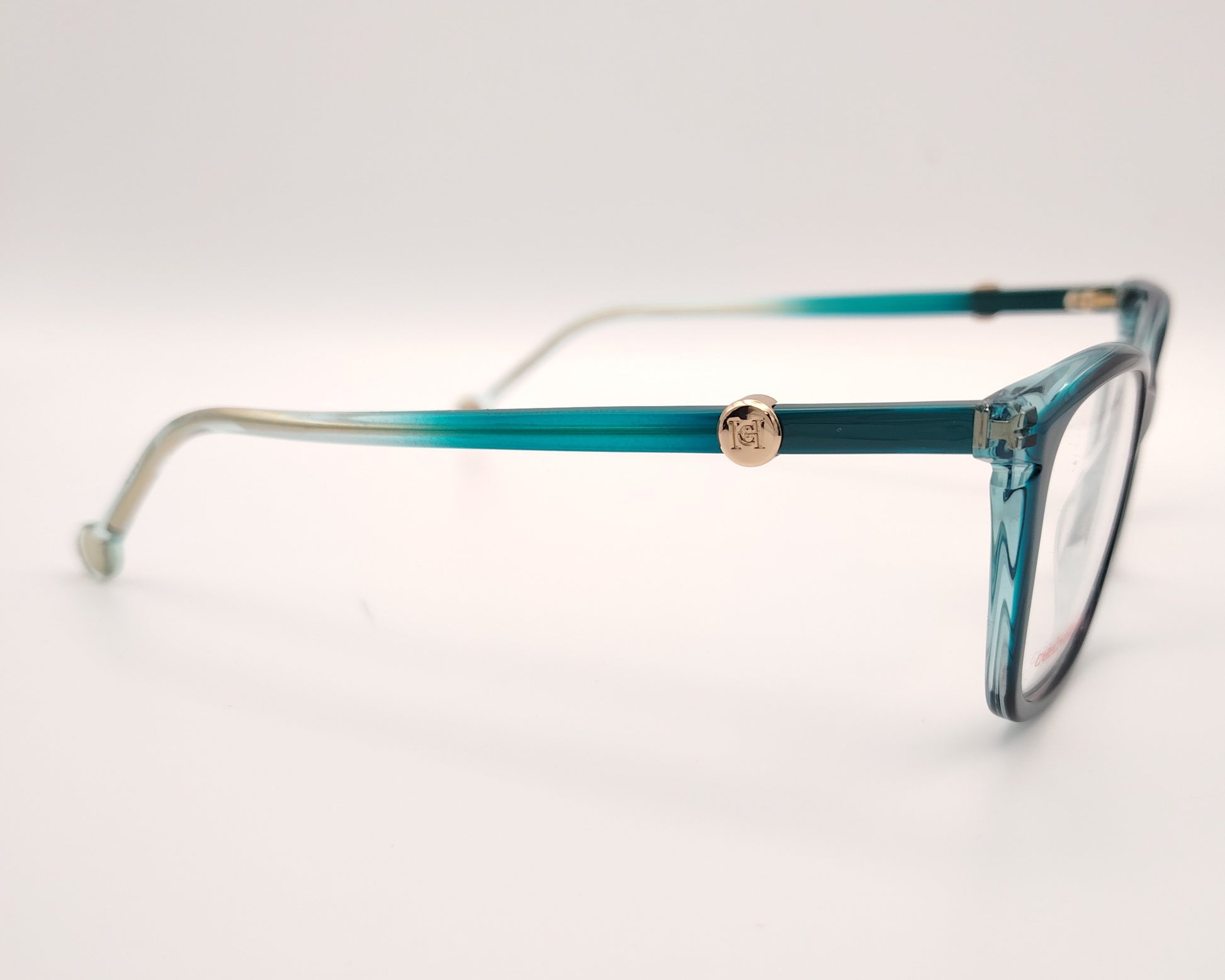 gafas graduadas carolina herrera azul petróleo translúcidas con forma cat eye  suave y detalle dorado