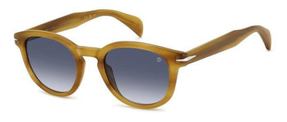 gafas de sol con montura translúcida color miel y lentes degradadas azules de forma redondeada