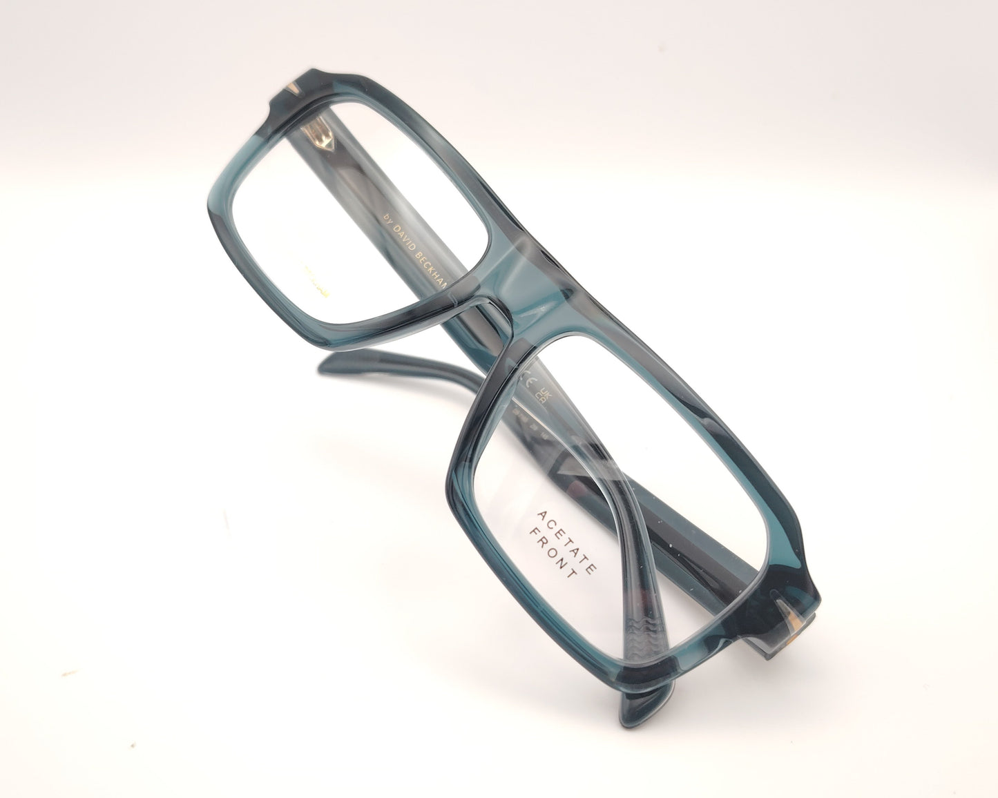 gafas graduadas rectangulares de acetato azul petróleo translúcido con detalle metálico en las varillas