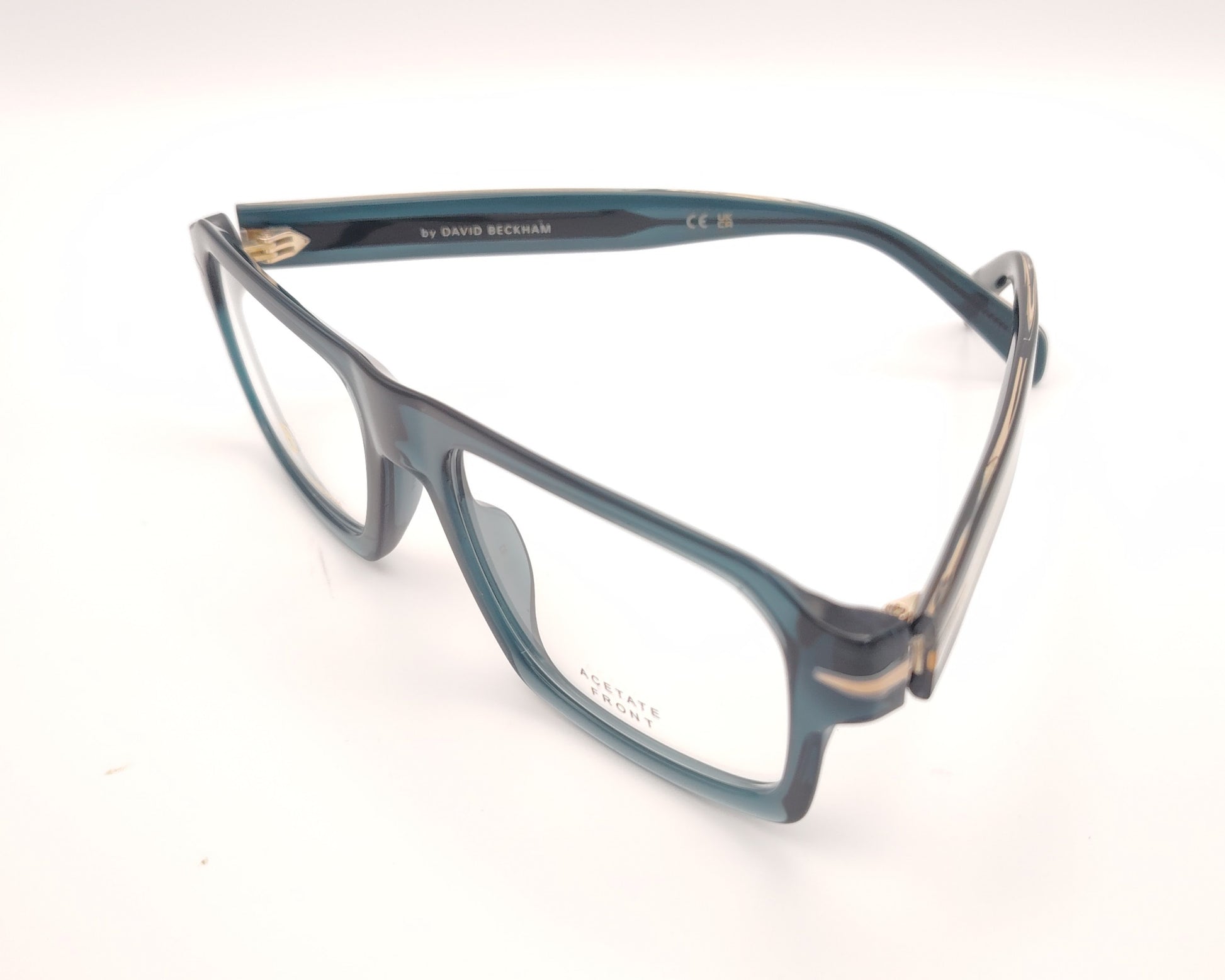 gafas graduadas rectangulares de acetato azul petróleo translúcido con detalle metálico en las varillas