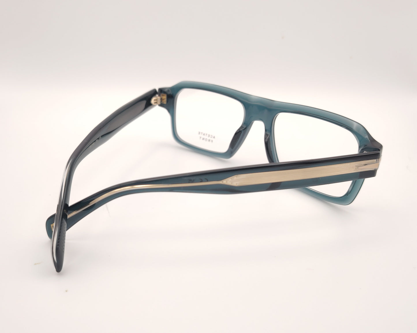 gafas graduadas rectangulares de acetato azul petróleo translúcido con detalle metálico en las varillas