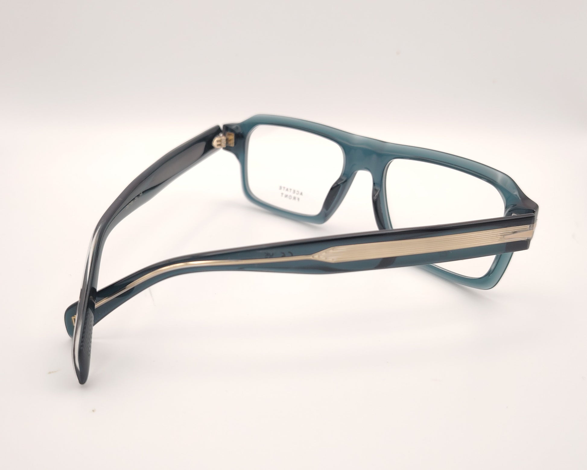 gafas graduadas rectangulares de acetato azul petróleo translúcido con detalle metálico en las varillas