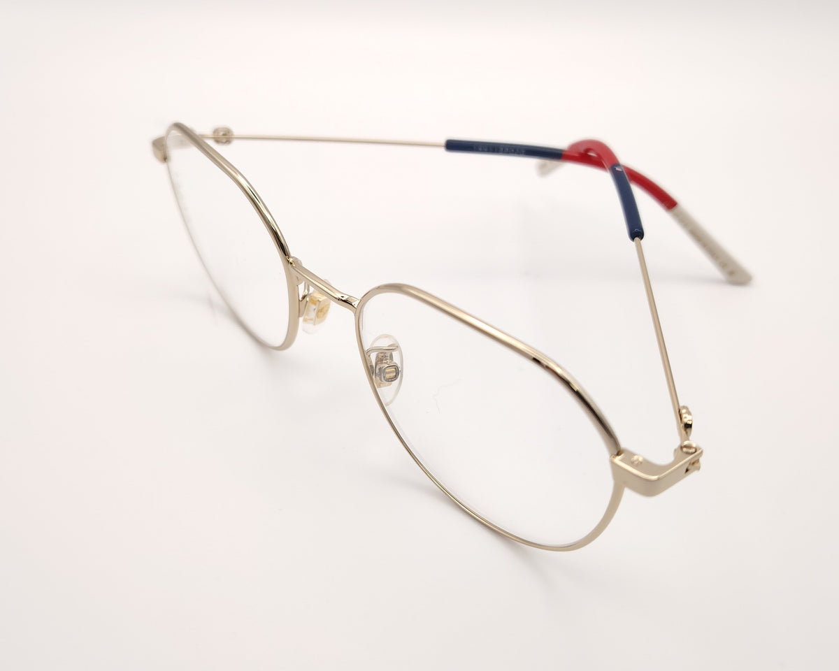 gafas gucci metálicas doradas con forma redonda y varillas en rojo azul y beige